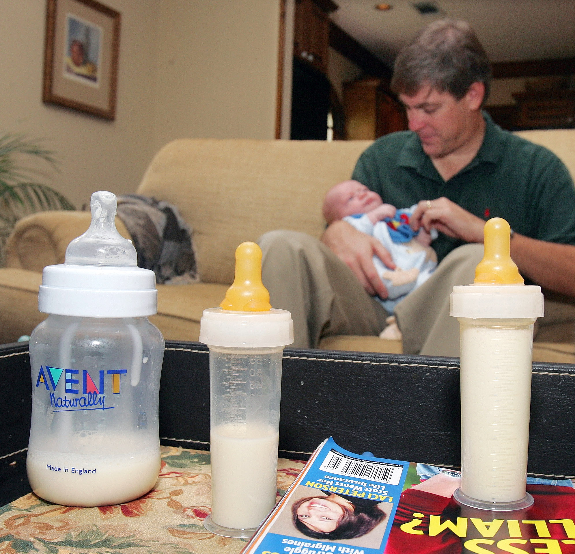 A dad feeds his baby