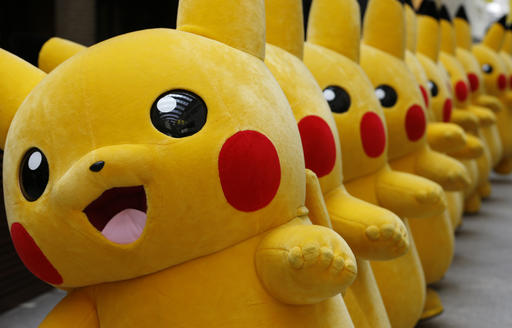 Dozens of Pokemon character Pikachu parade at a Japanese shopping district in 2016