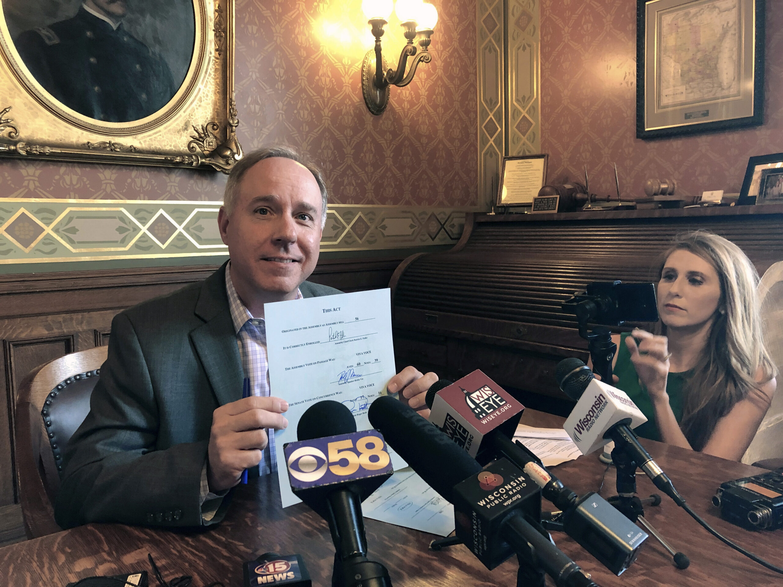 Wisconsin Assembly Speaker Robin Vos shows his signature on the budget before it's sent to the governor's desk