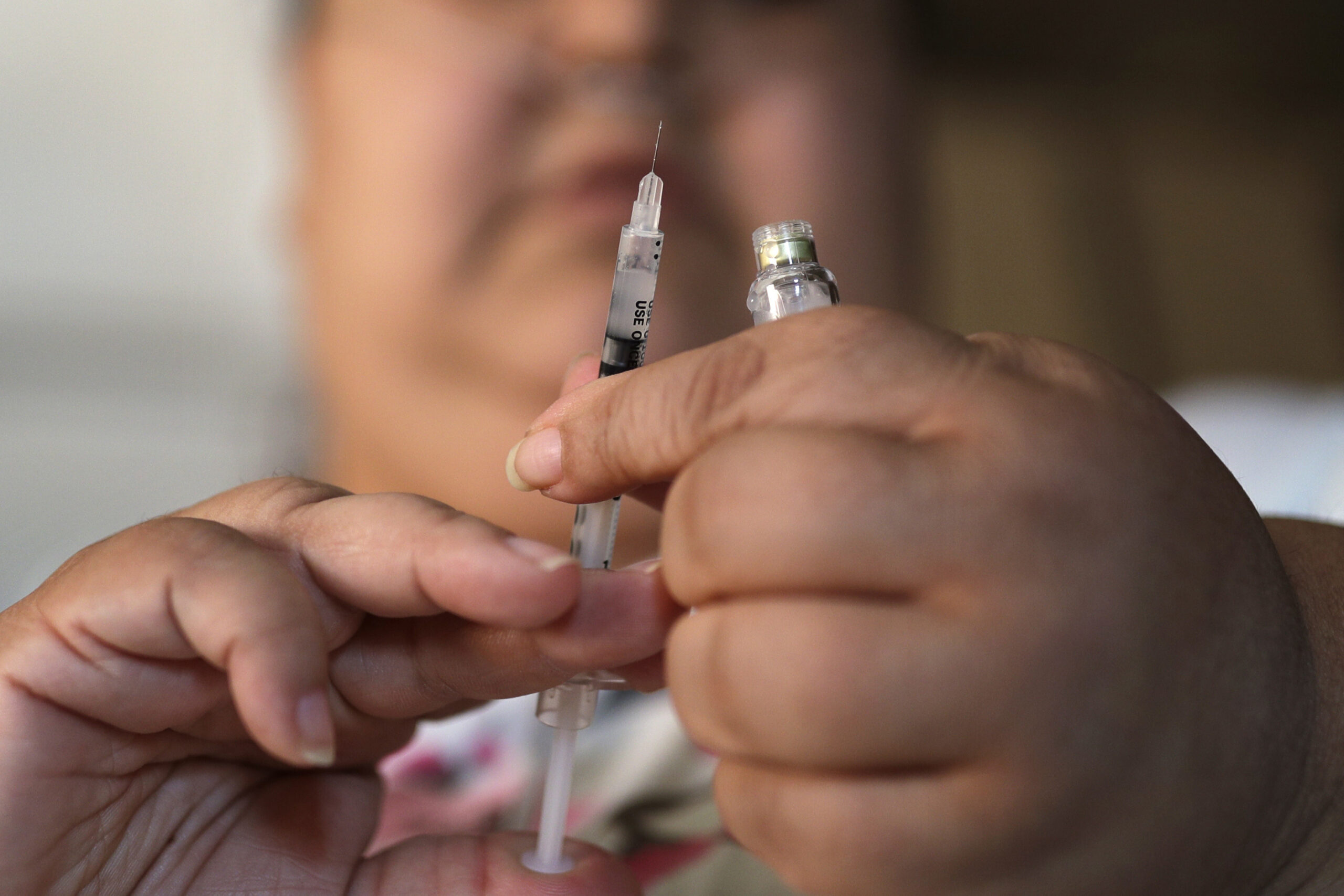 Woman holding insulin syringe for diabetes