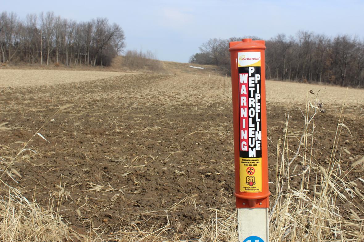An Enbridge post marks the Line 61 corridor in a field in Marshall, Wisconsin.