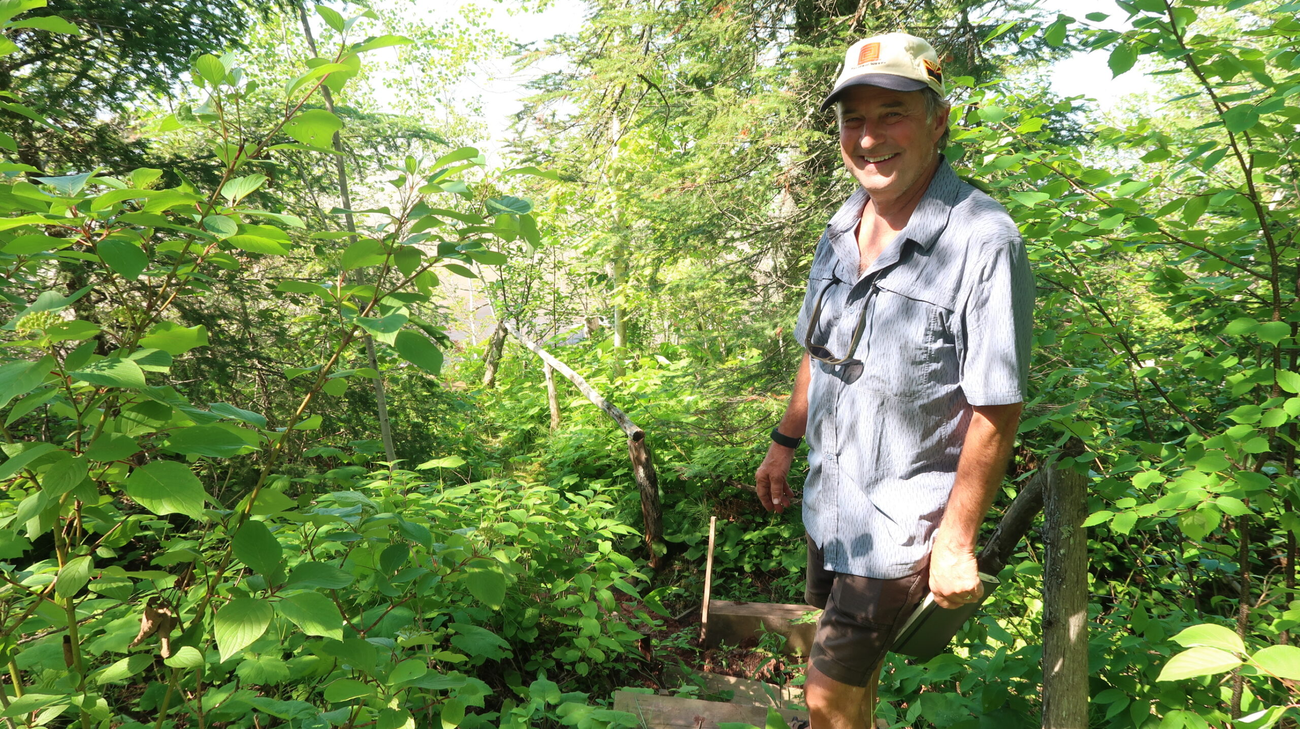 Ken Pray stands by a set of stairs damaged by erosion