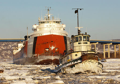 Tug breaking ice in Lake Superior for an ore carrier