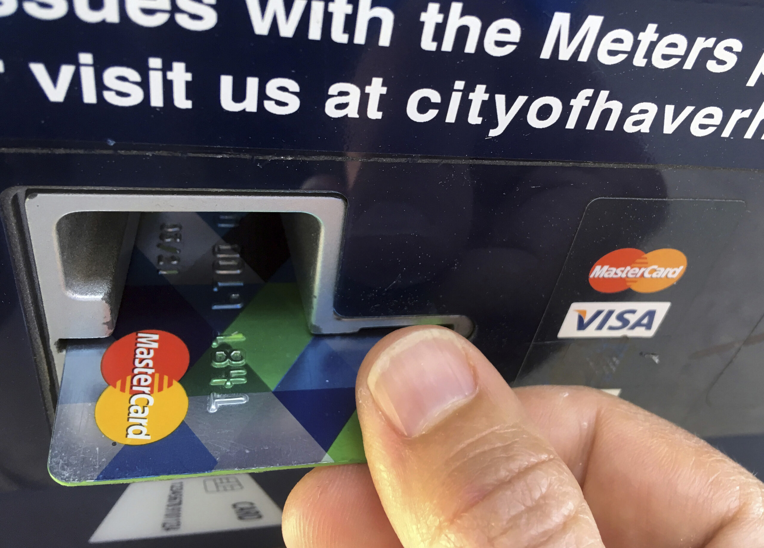 Credit card inserted into parking meter