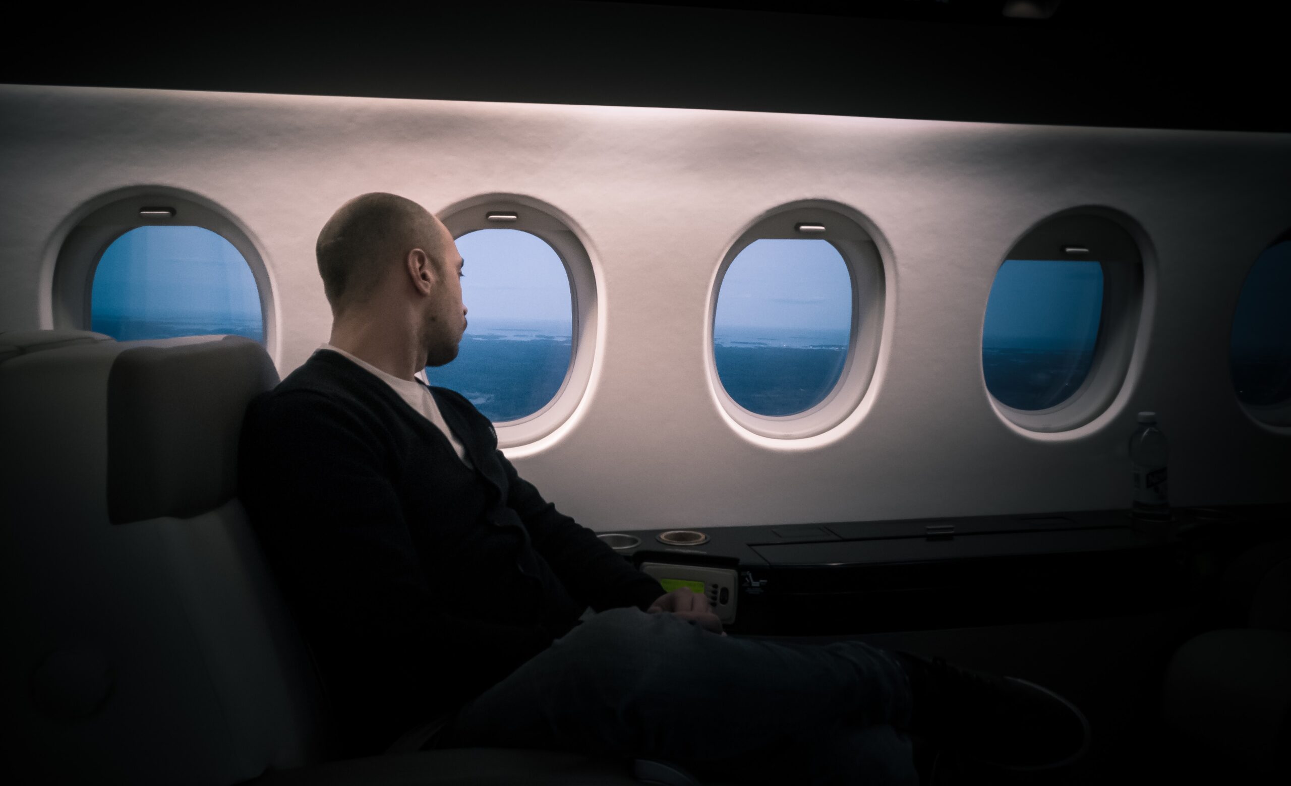 man on airplane sitting near window
