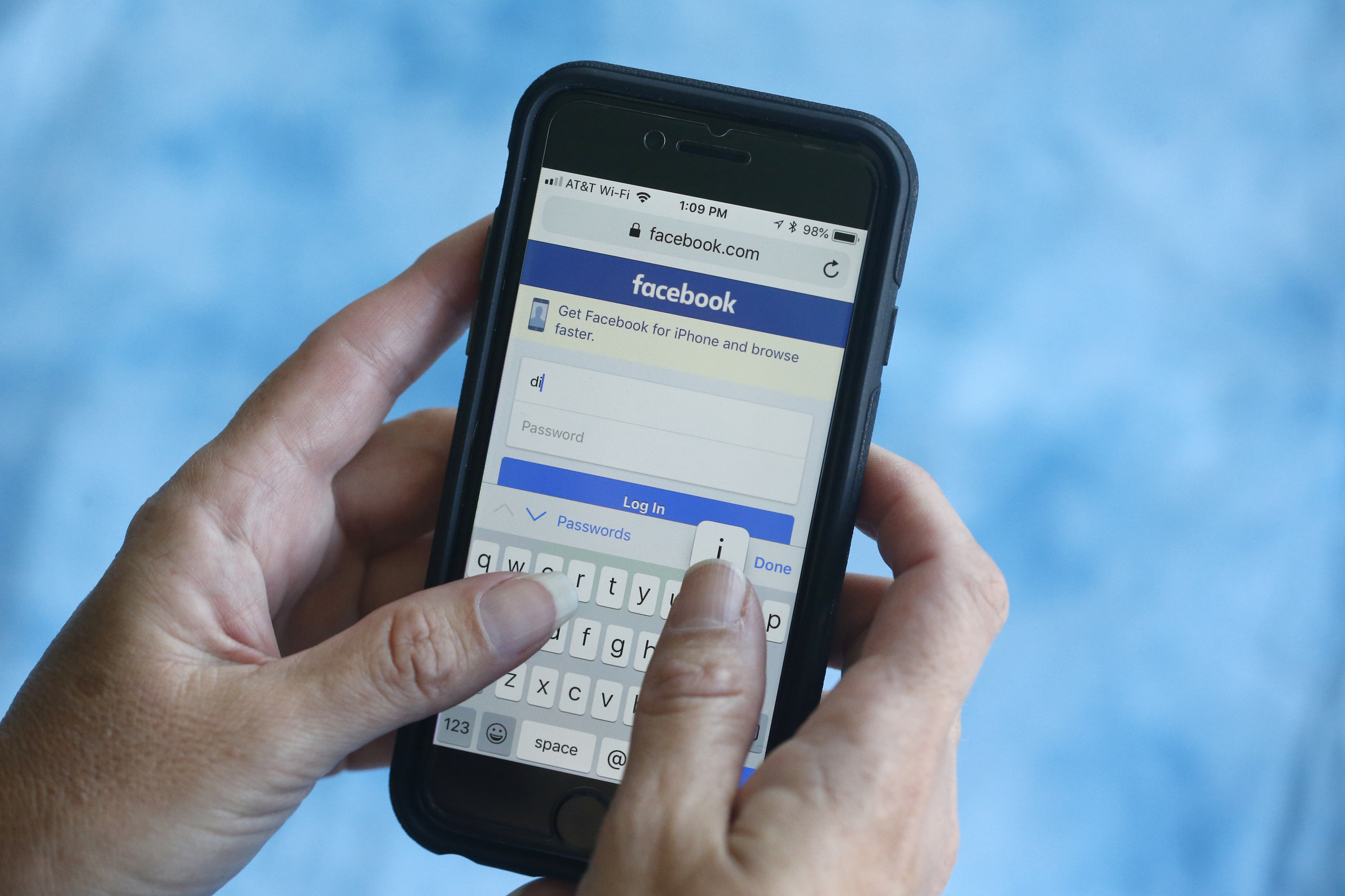 A smartphone user logs into Facebook