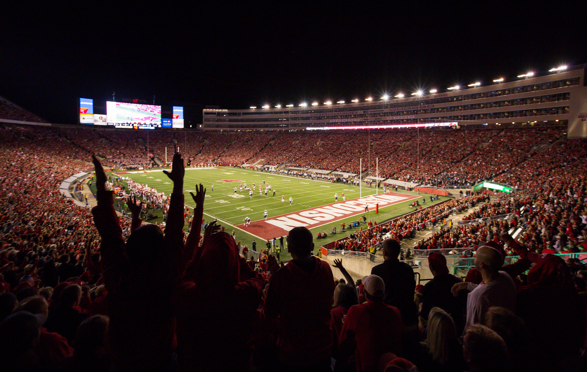 Fans celebrate after Wisconsin scored against Utah State during a football game in Madison, Wis.