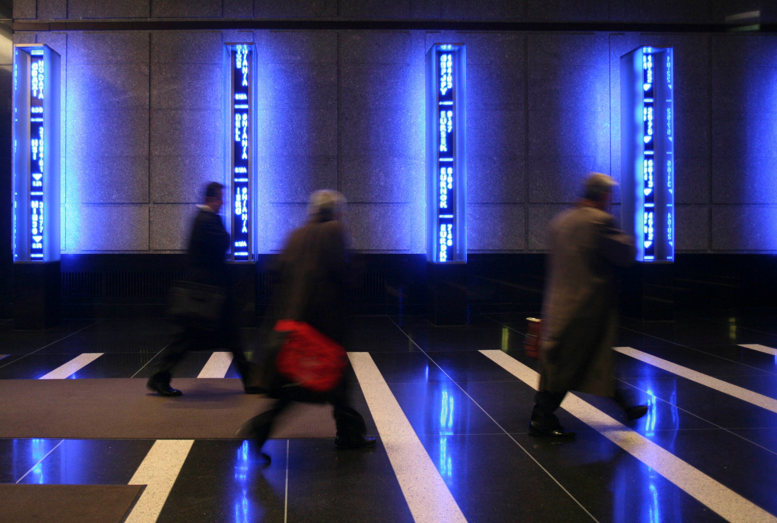 Employees cross the lobby at Bear Stearns