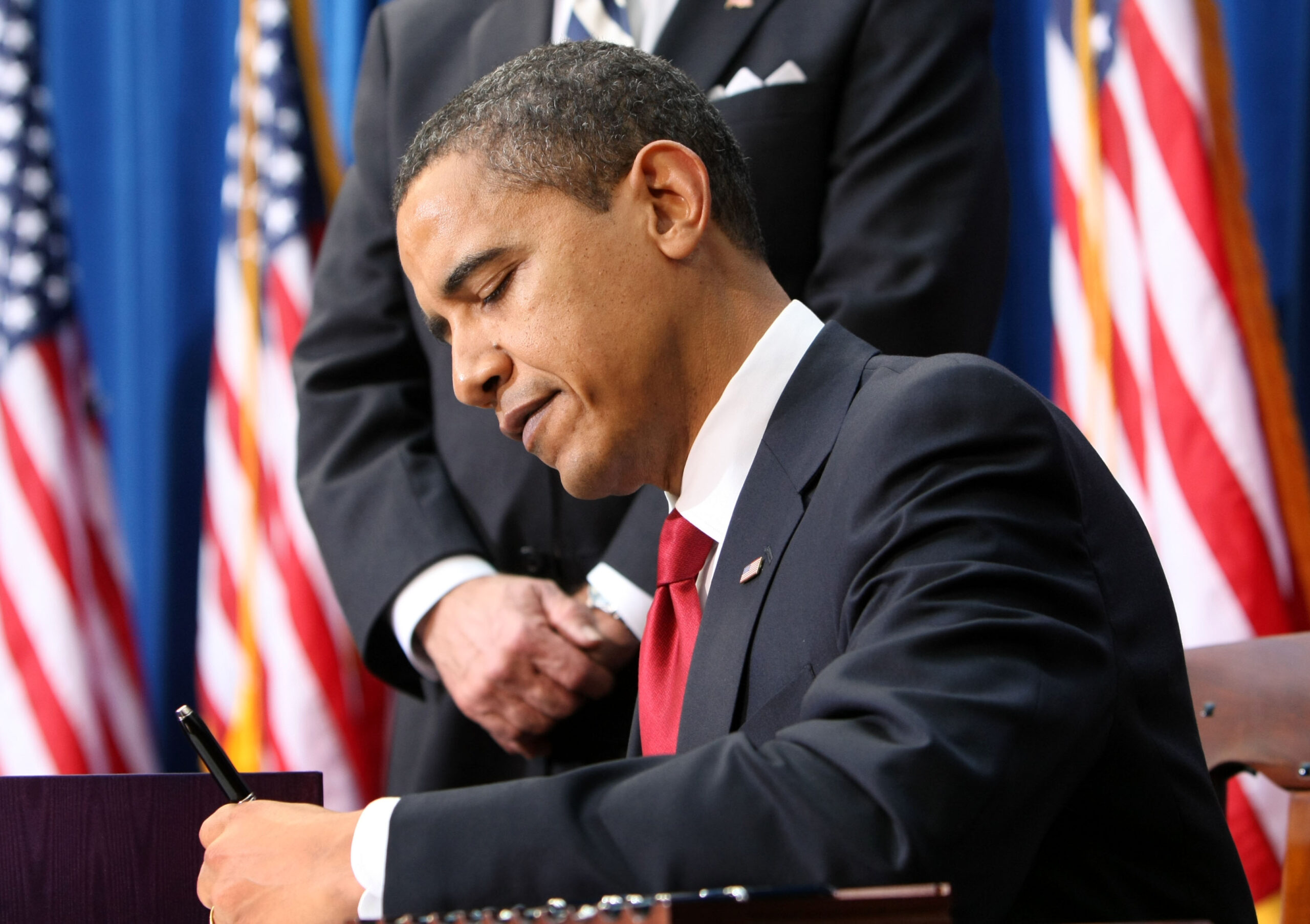 President Barack Obama signs the American Recovery and Reinvestment Act