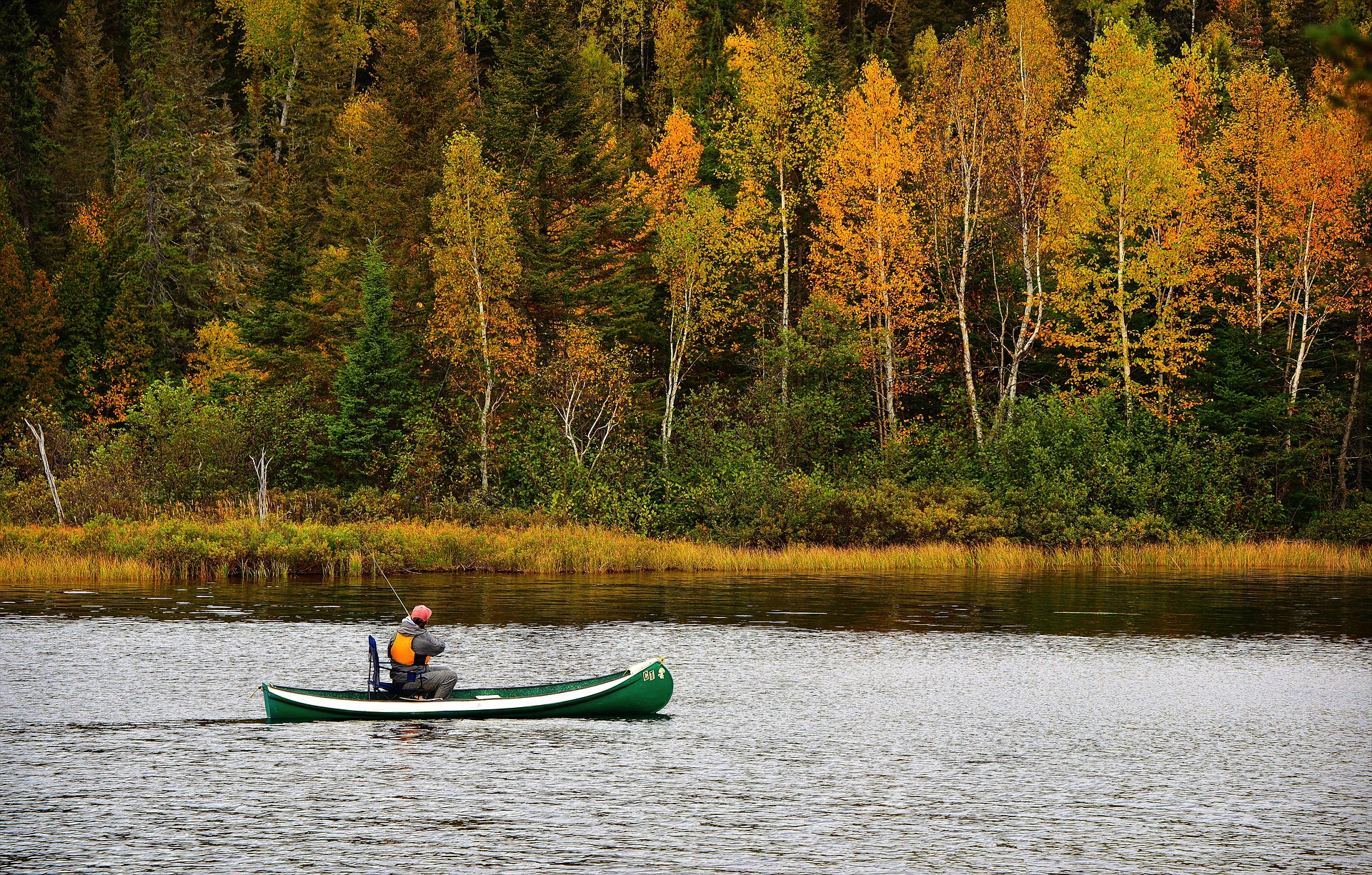 Fishing in a canoe on a fall day.