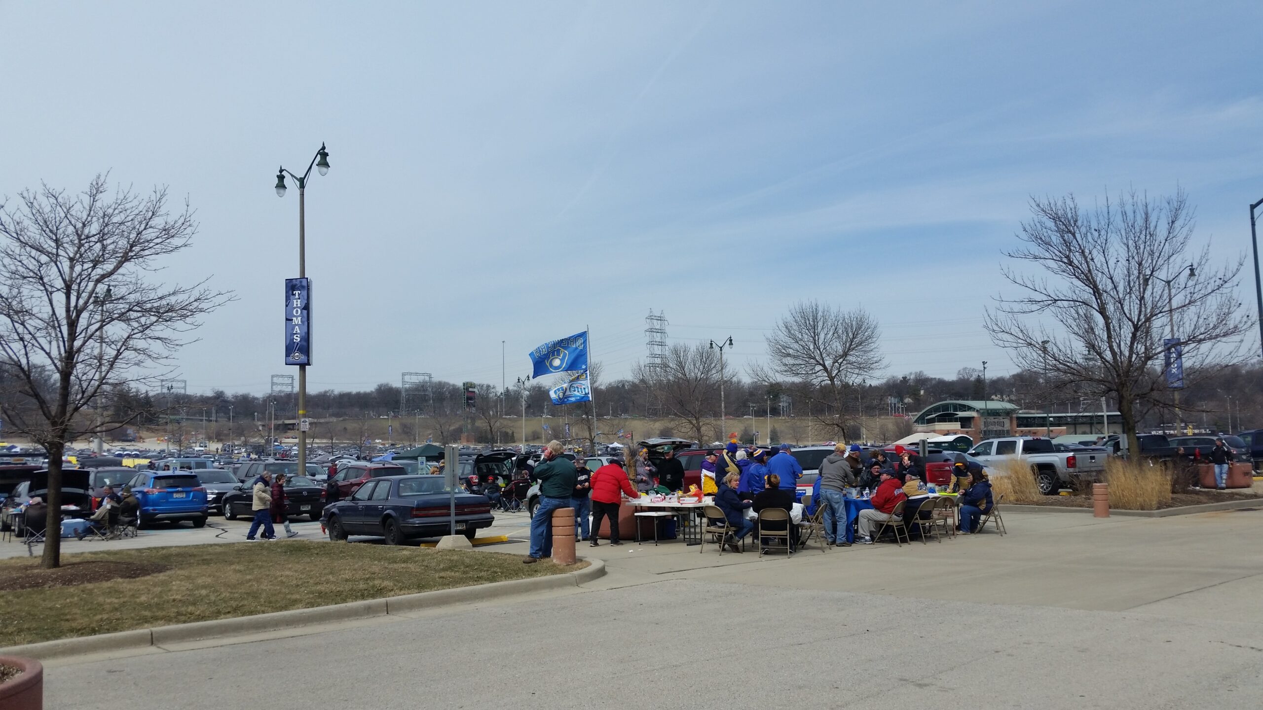 Fans tailgate in the parking lot outside Miller Park