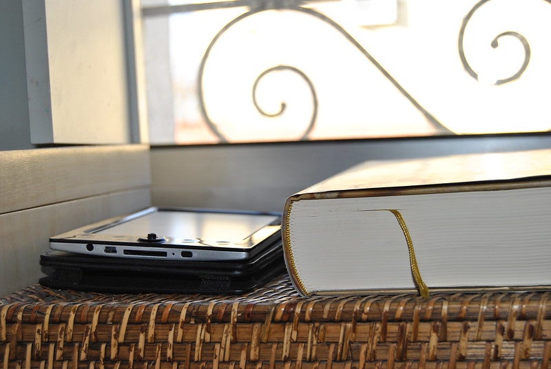 e-book sitting next to hardcover book