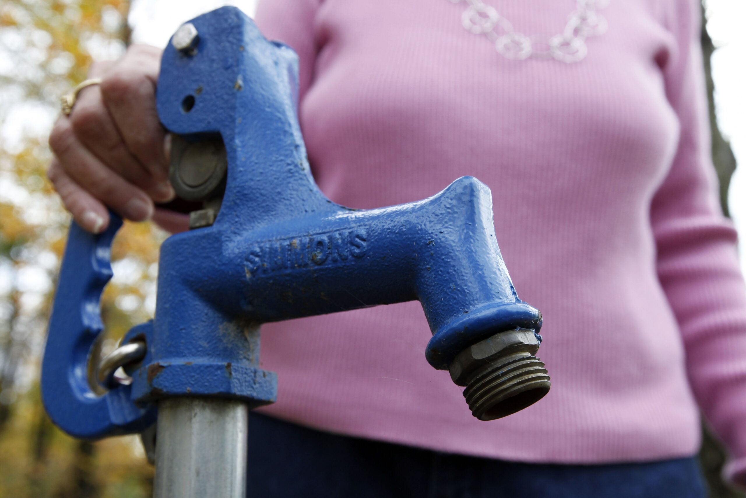 Jean Carter with the water spigot used to test her well water