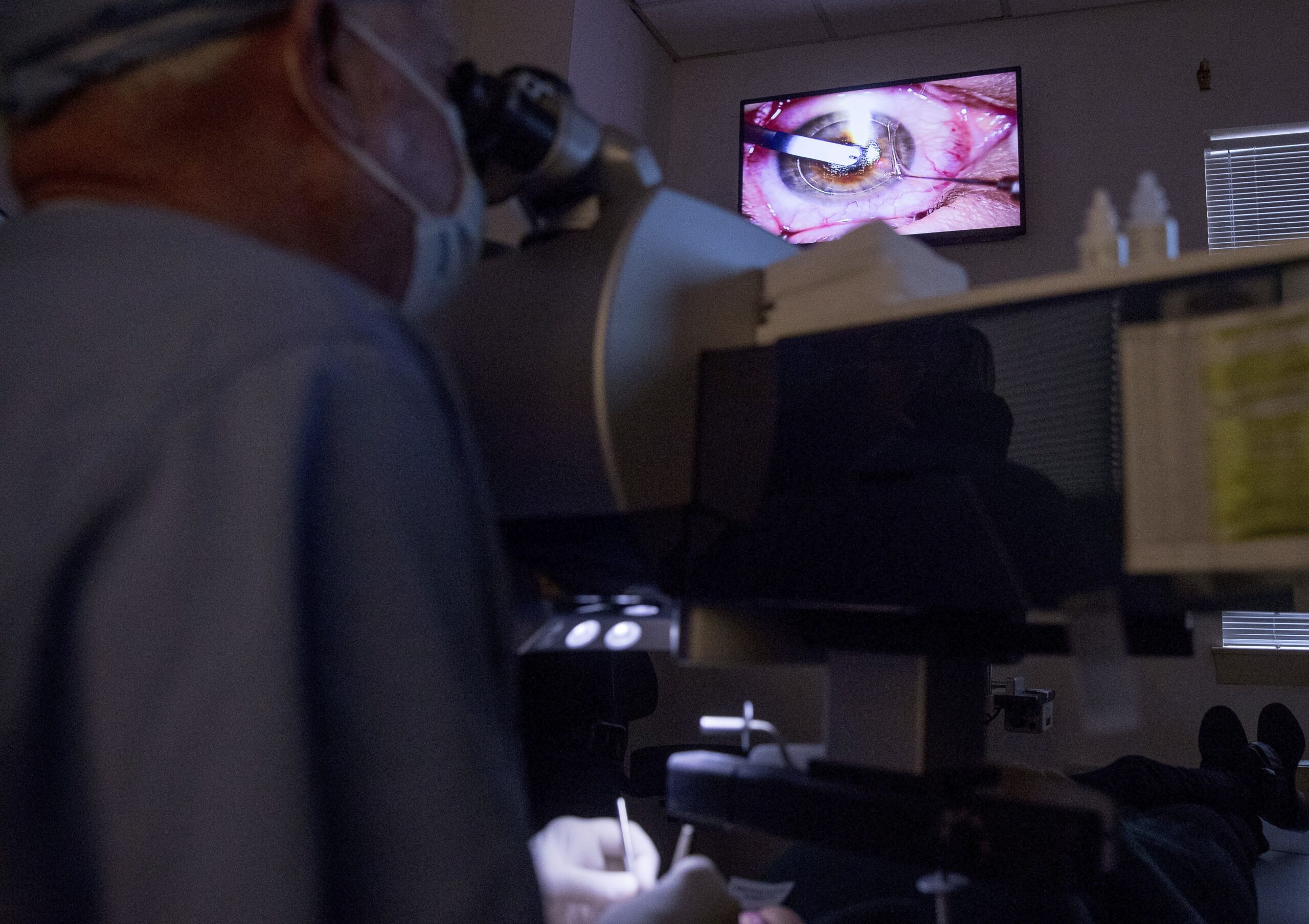 Ophthalmologist performs an eye surgery