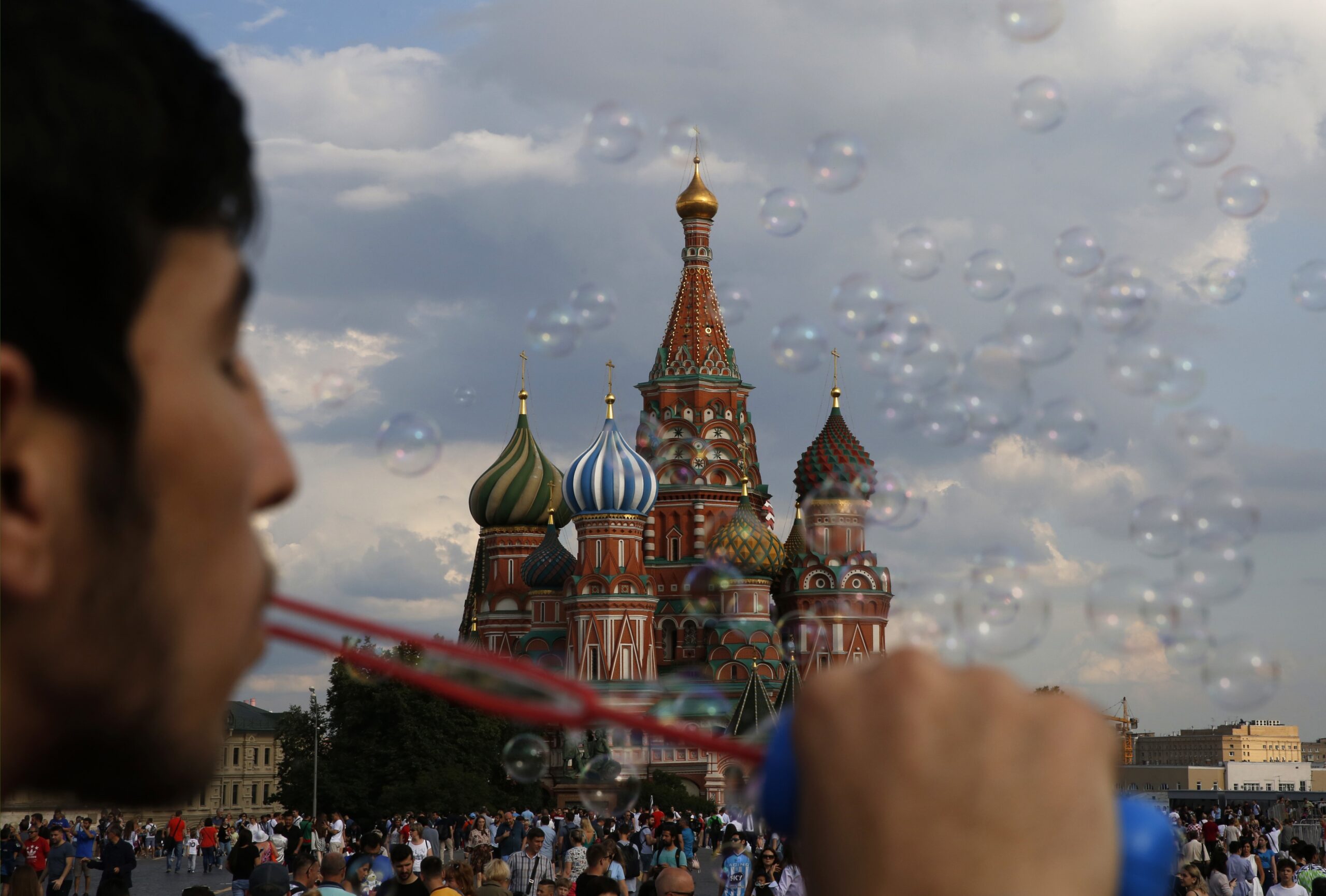 A young man blows bubbles in Red Square during the 2018 soccer World Cup