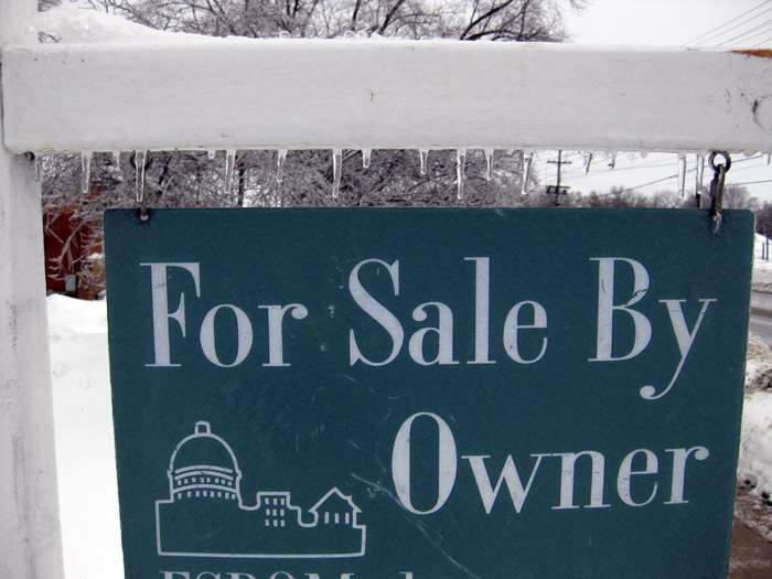 Home for sale sign in winter