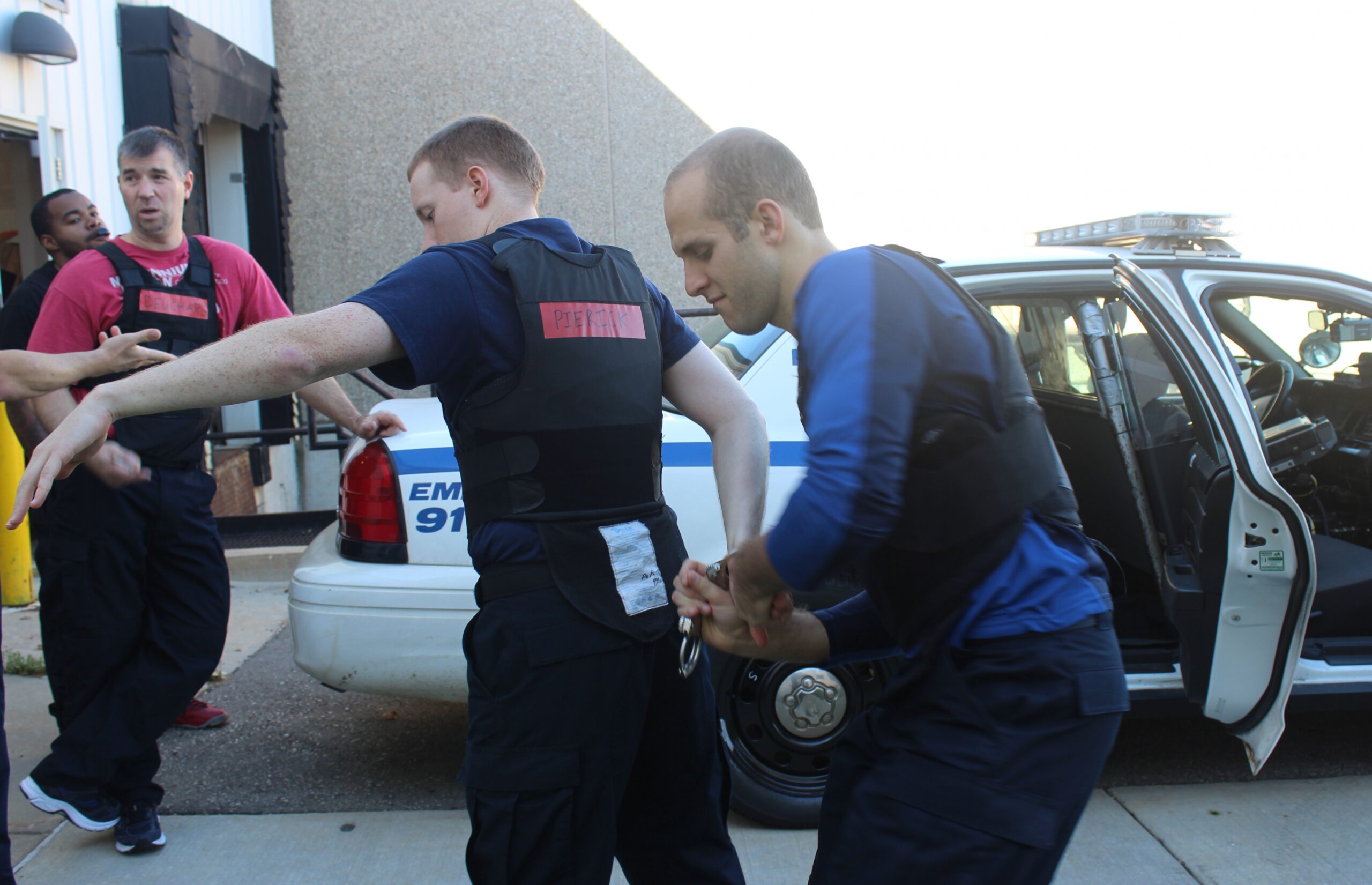 Madison Police recruits Ethan Pierick and Jack Graziano practice handcuffing at the Madison Police Training Center.