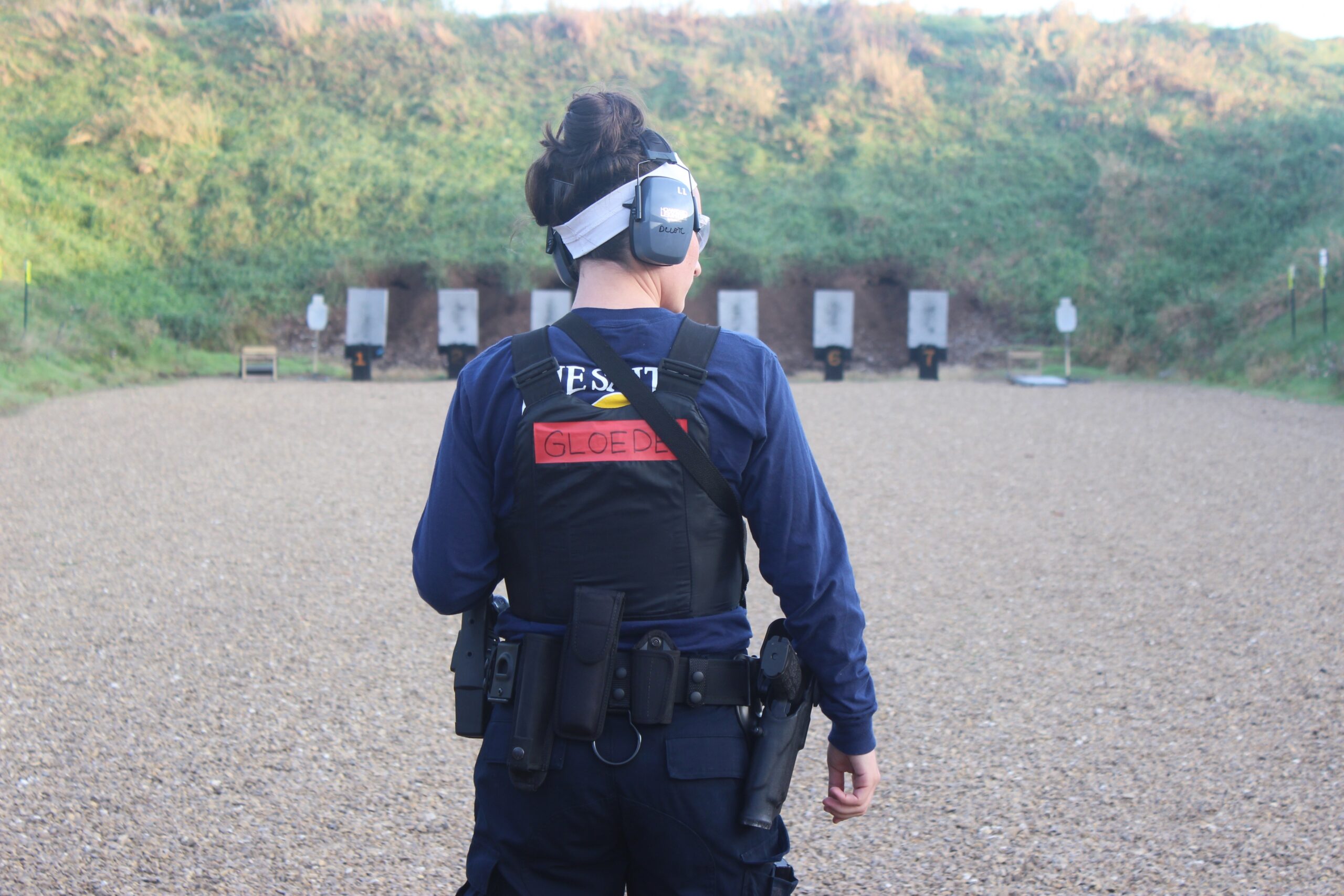 Recruit Clare Gloede listens to instructions at the Dane County Law Enforcement Training Center shooting range.