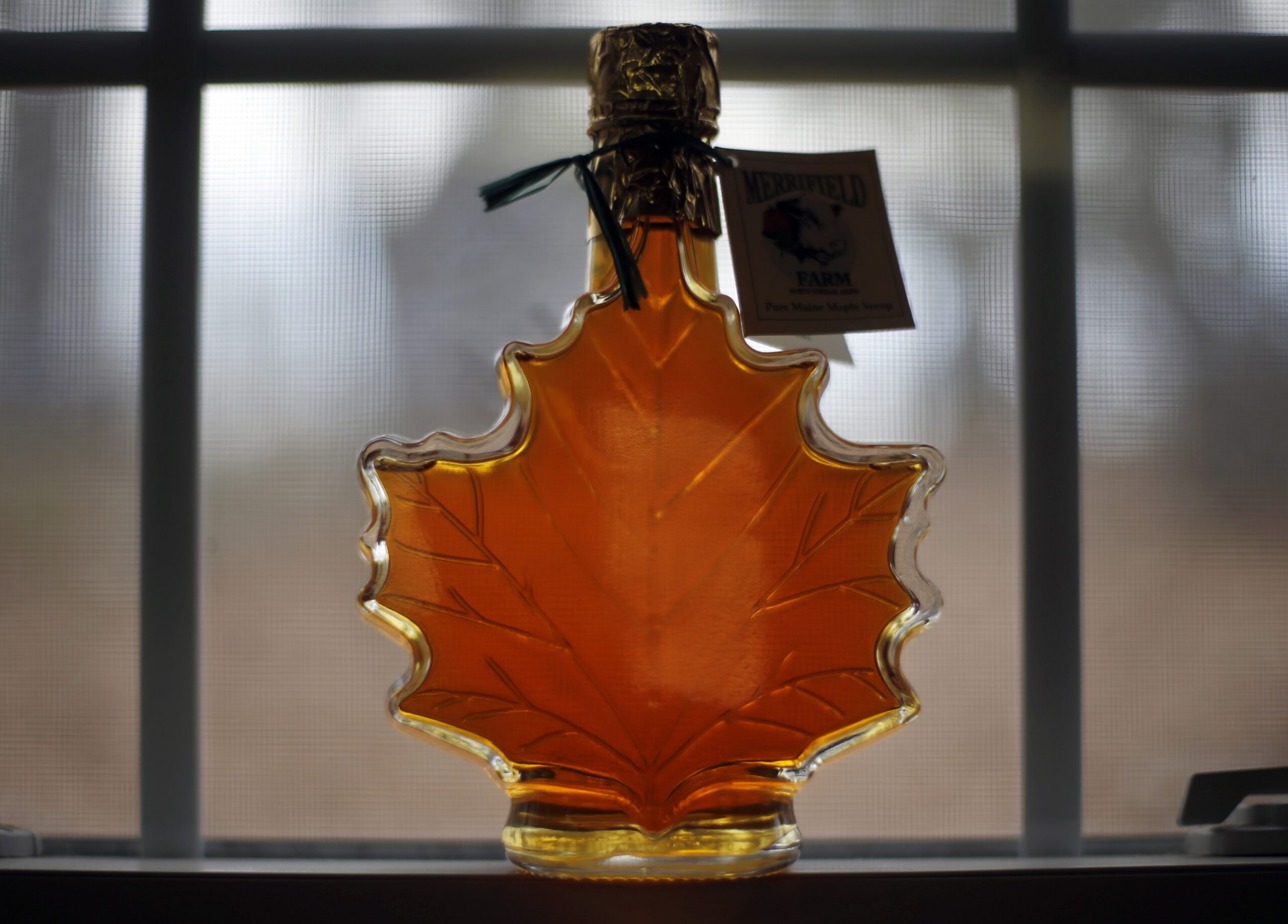 Maple syrup in a maple leaf-shaped bottle