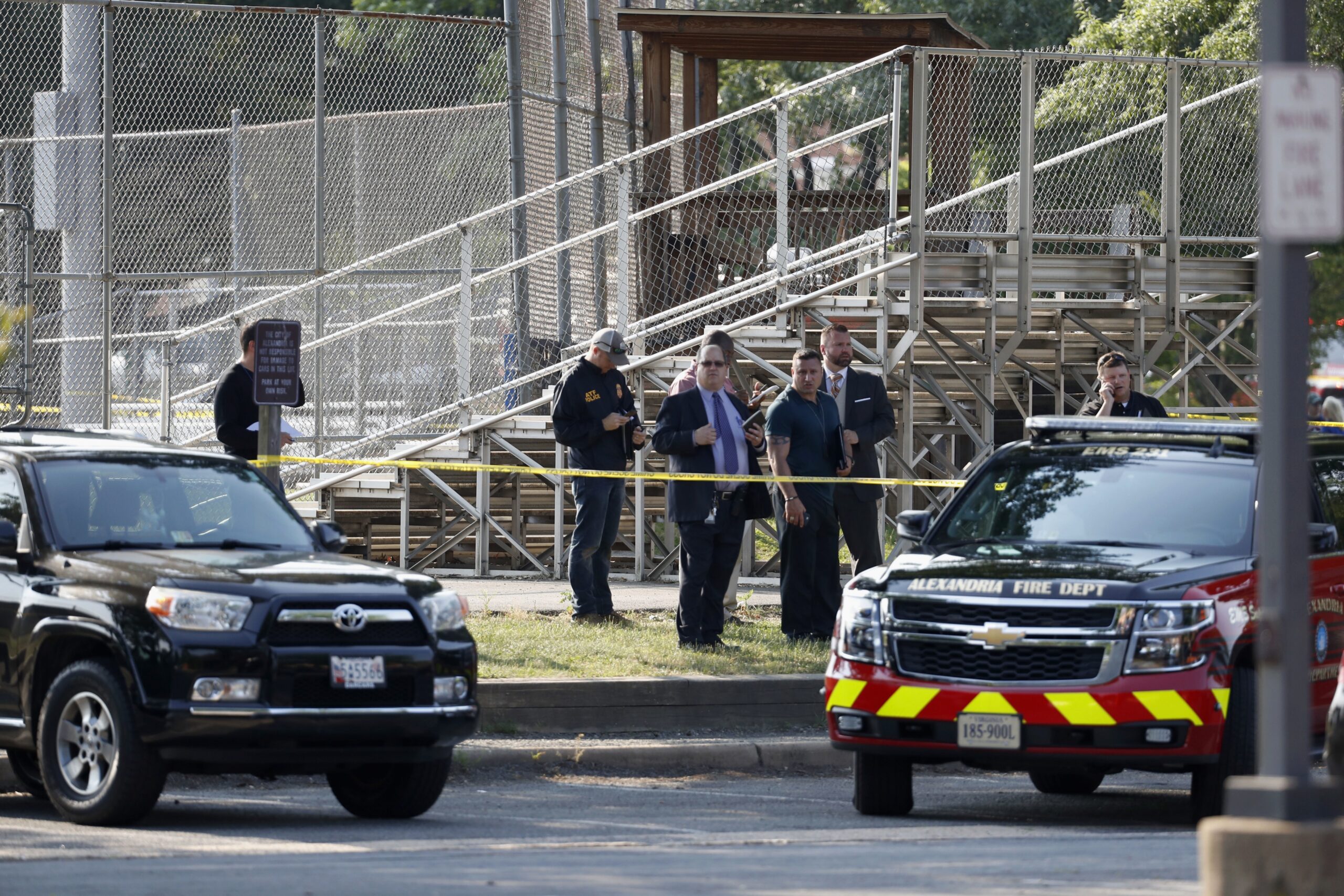 Law enforcement officers investigate the scene of a shooting near a baseball field in Alexandria, Virginia
