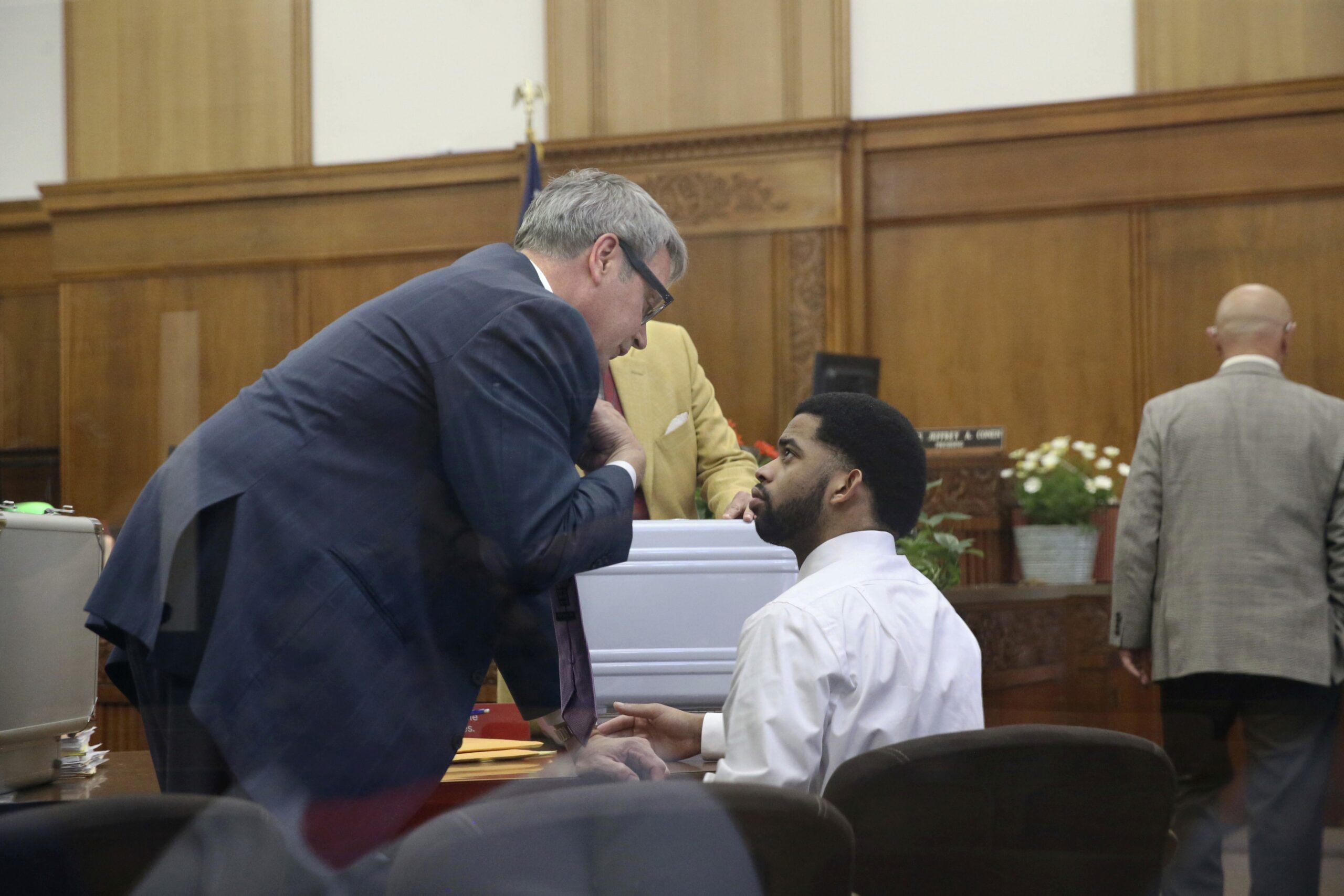 Dominique Heaggan-Brown speaks with his attorney Jonathan C. Smith