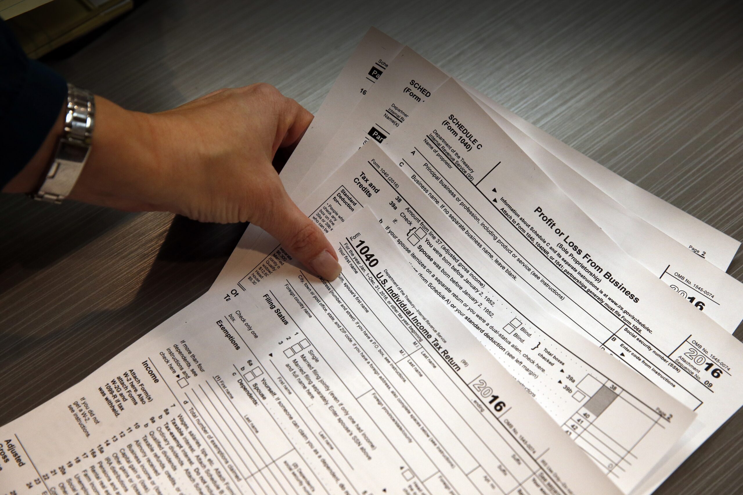 tax professional holds tax forms