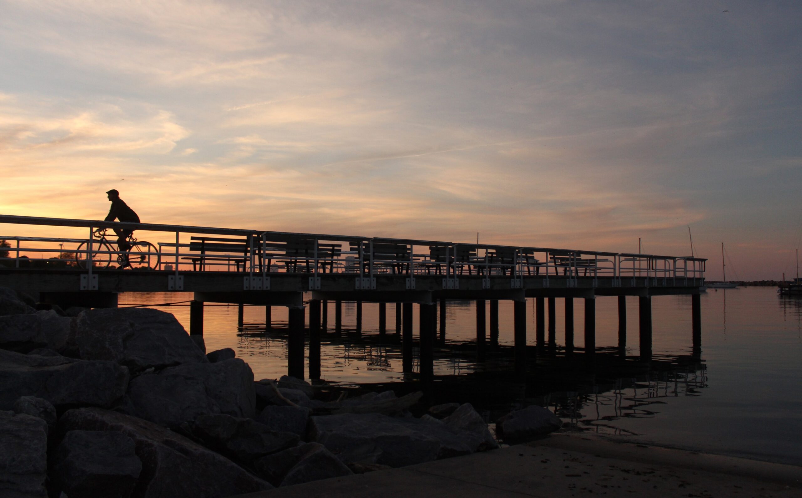 Cyclist riding along pier on Lake Michigan in Milwaukee