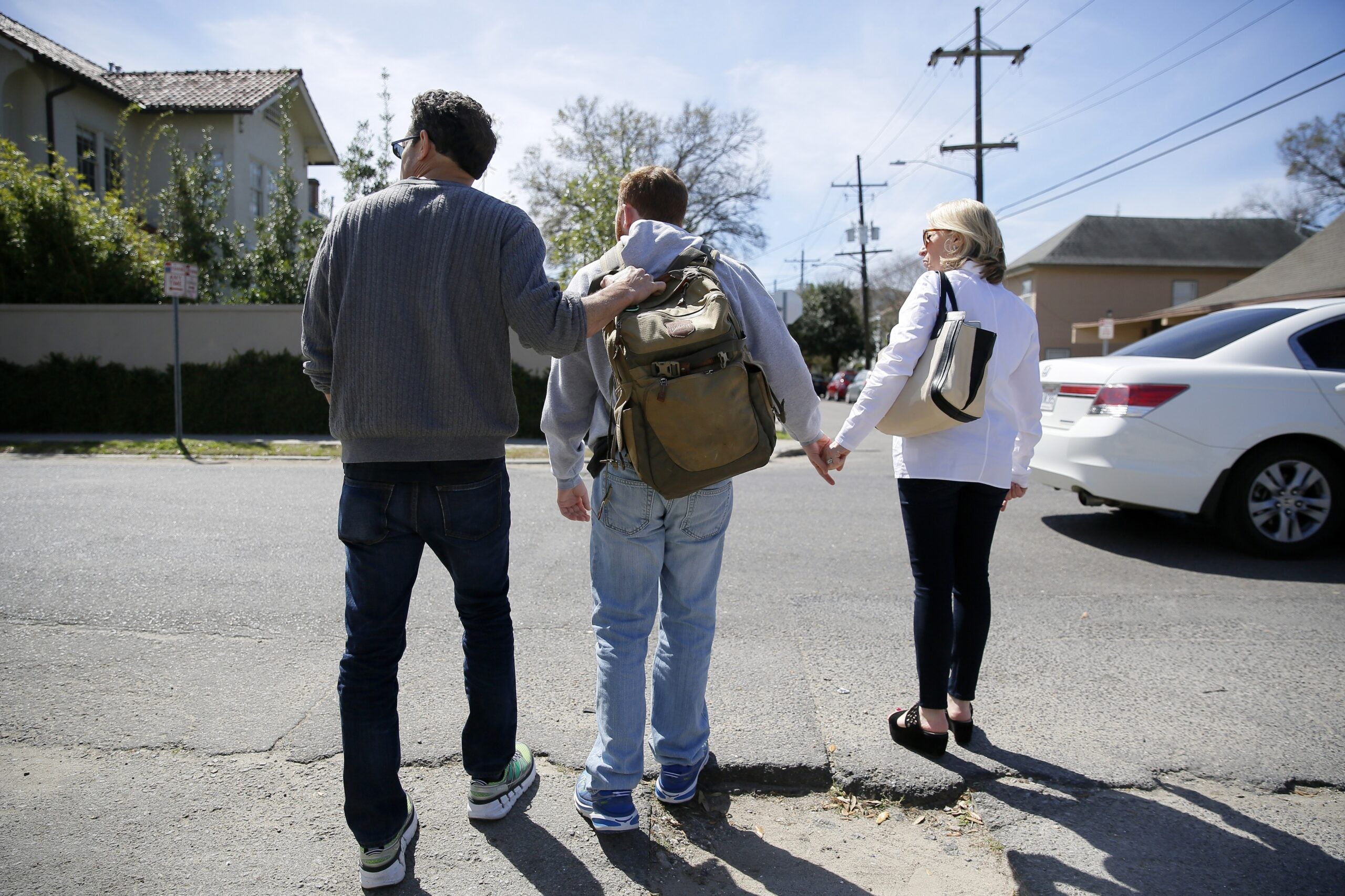 A family crossing a street