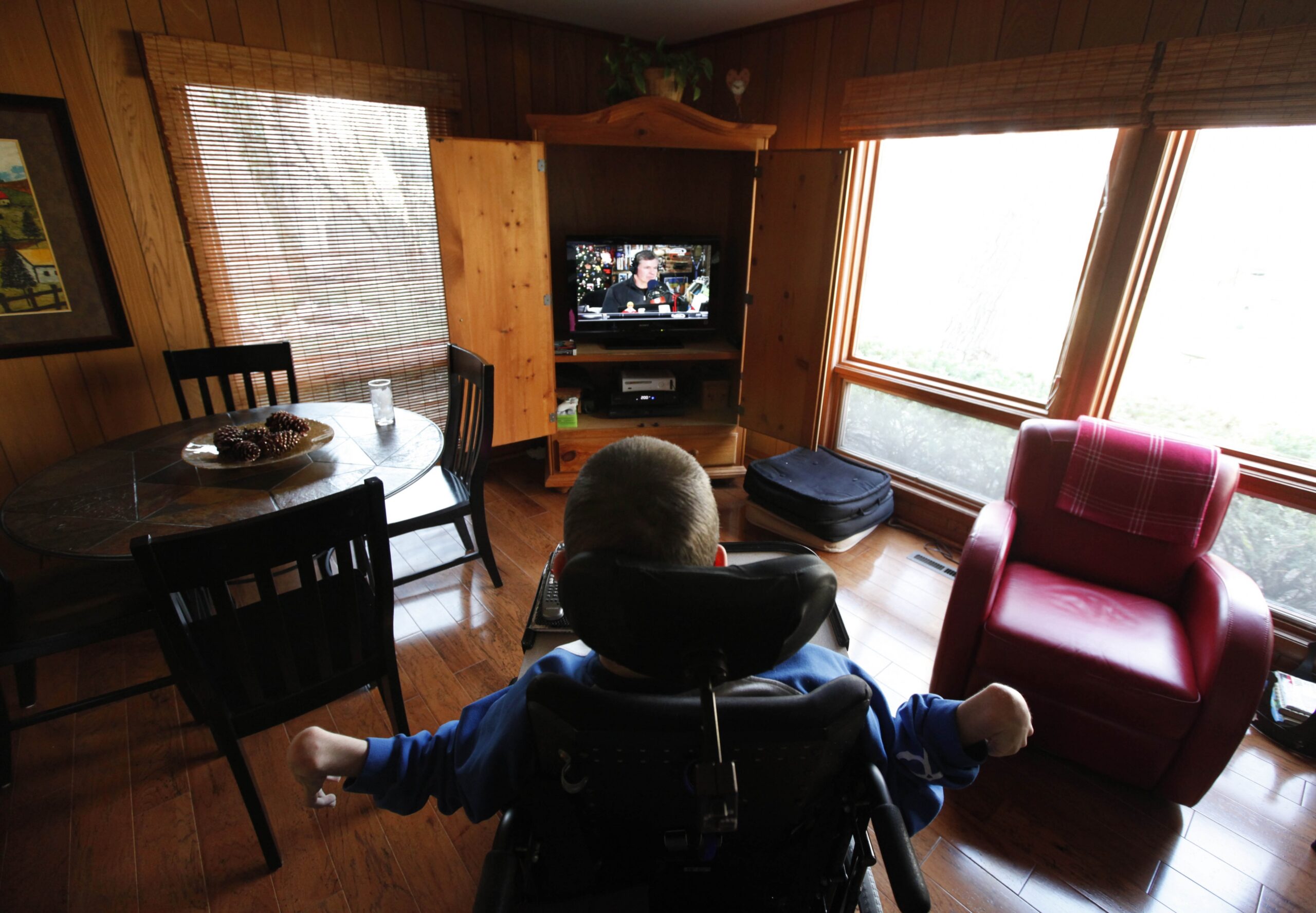 Mike Berkson, a 22-year old with cerebral palsy, watches tv