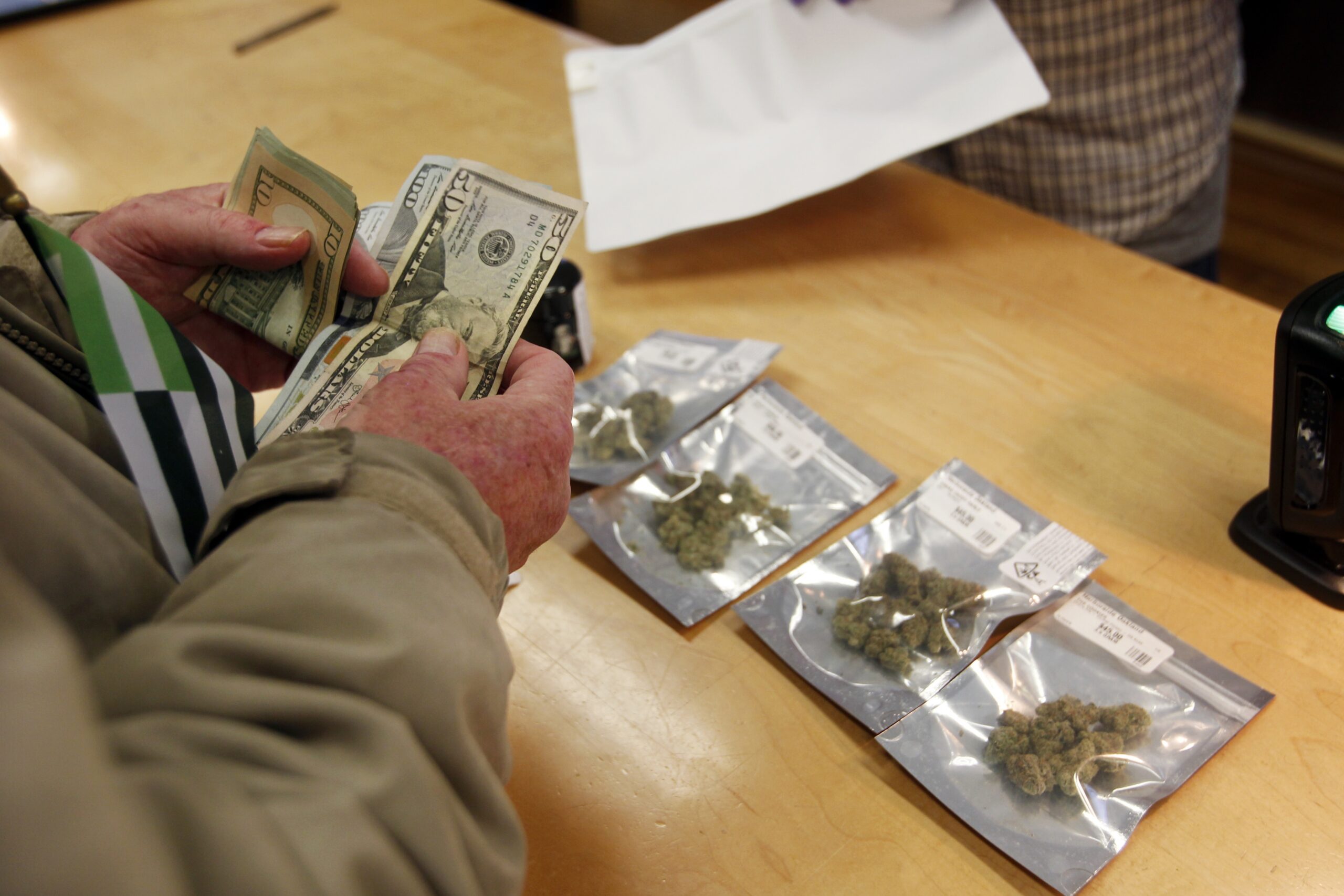 Person pays cash for bags of marijuana