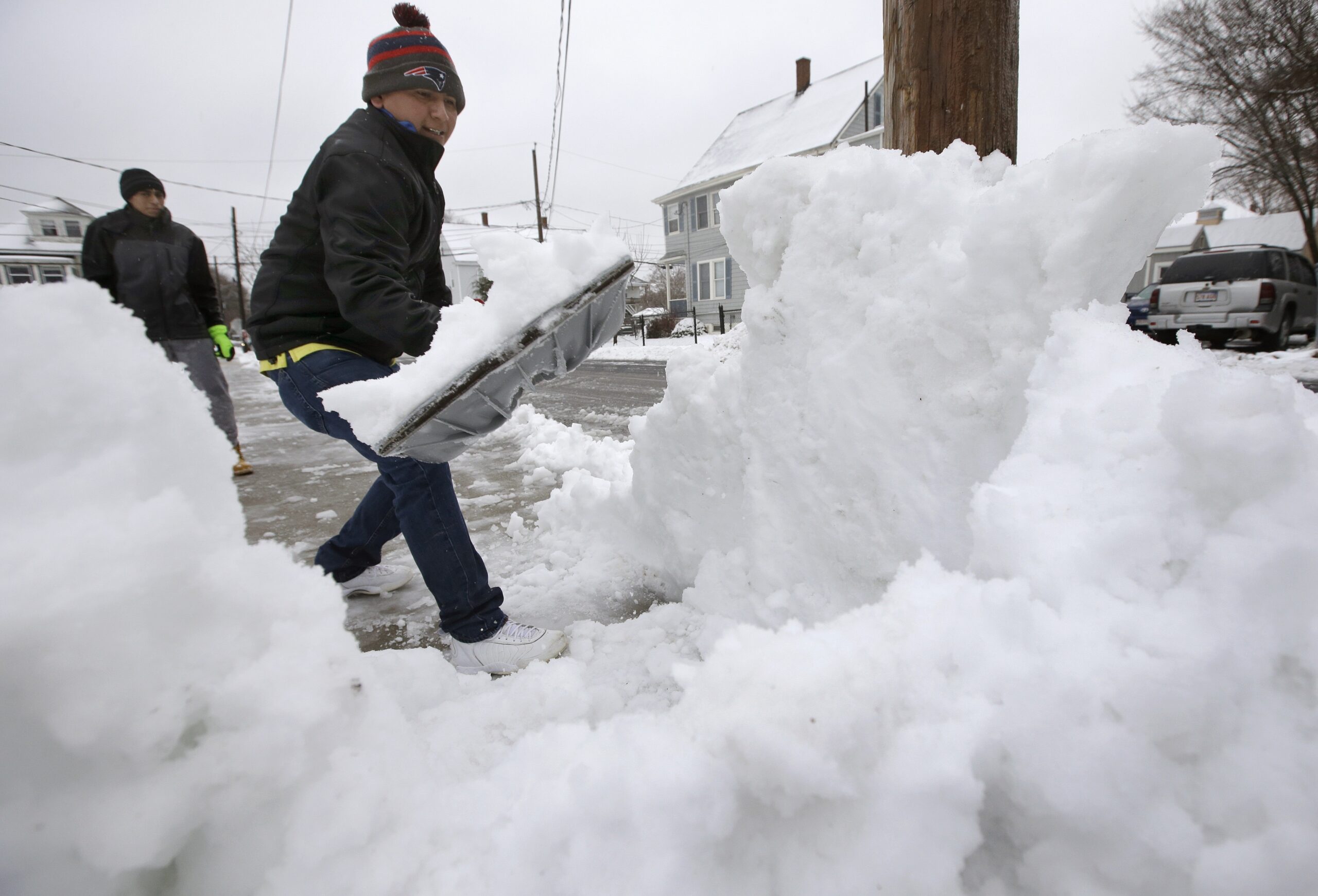 Miguel Delao shovels snow in front of his home this winter