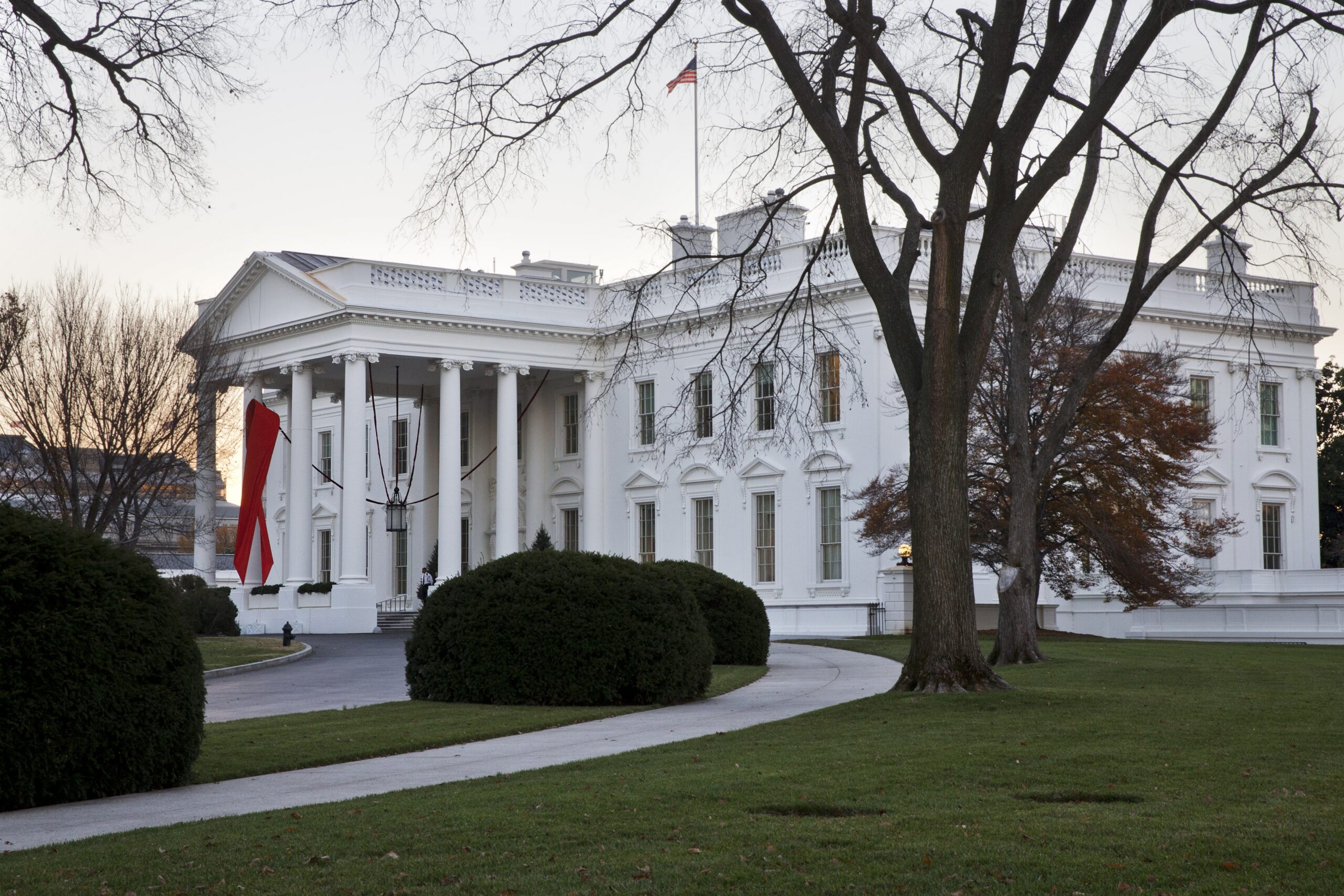 The White House is decorated with a red ribbon in honor of World AIDS Day