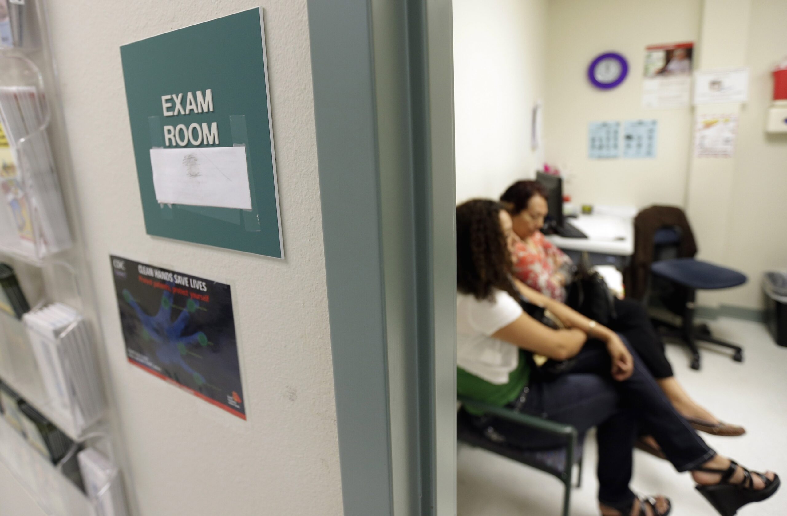 two women wait in an exam room at a doctor's office