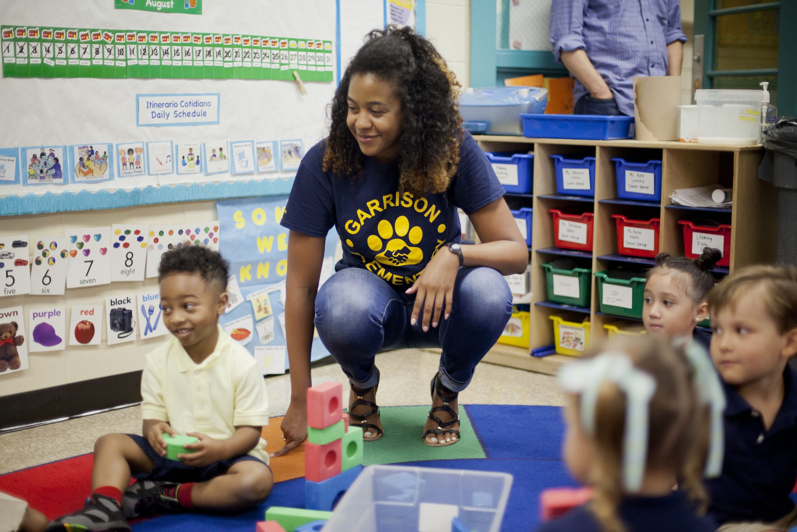 Epernay Kyles, center, Pre-K teacher at Garrison Elementary in the Logan Circle neighborhood in Washington, meets with her students on the first day of classes