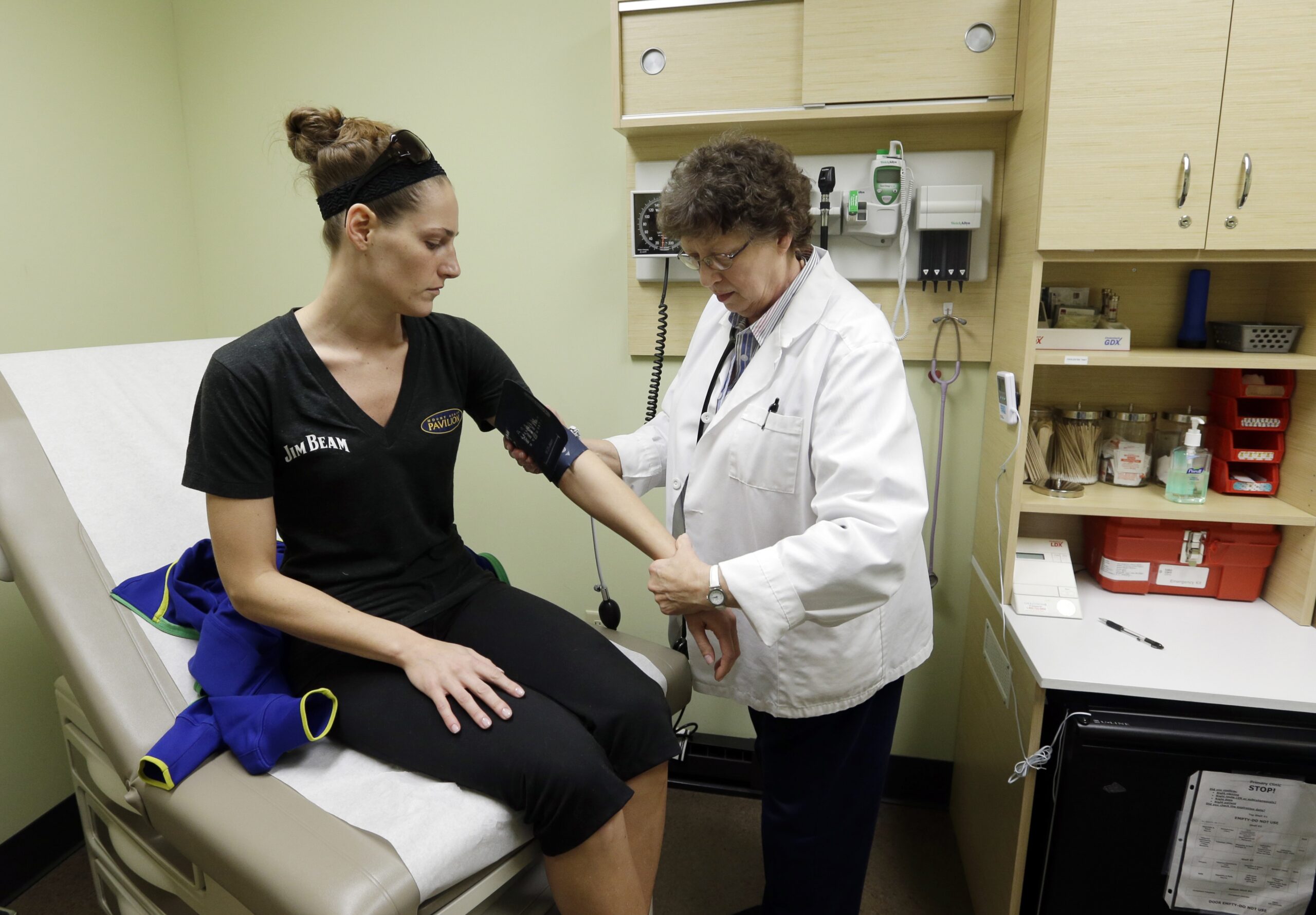 Family Nurse Practitioner Ruth Wiley examines Elizabeth Knowles at a Walgreens Take Care Clinic