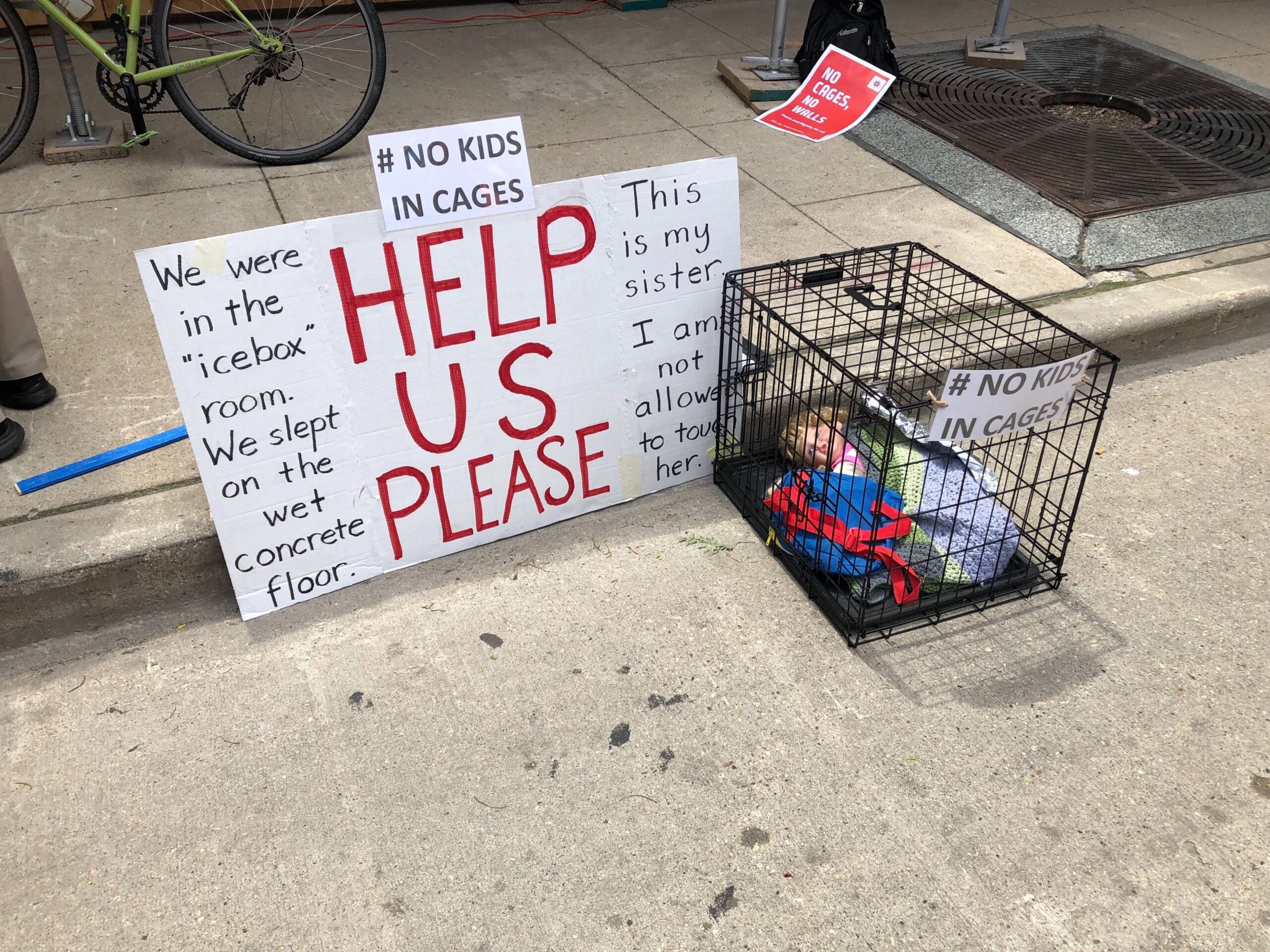 a baby doll in a cage