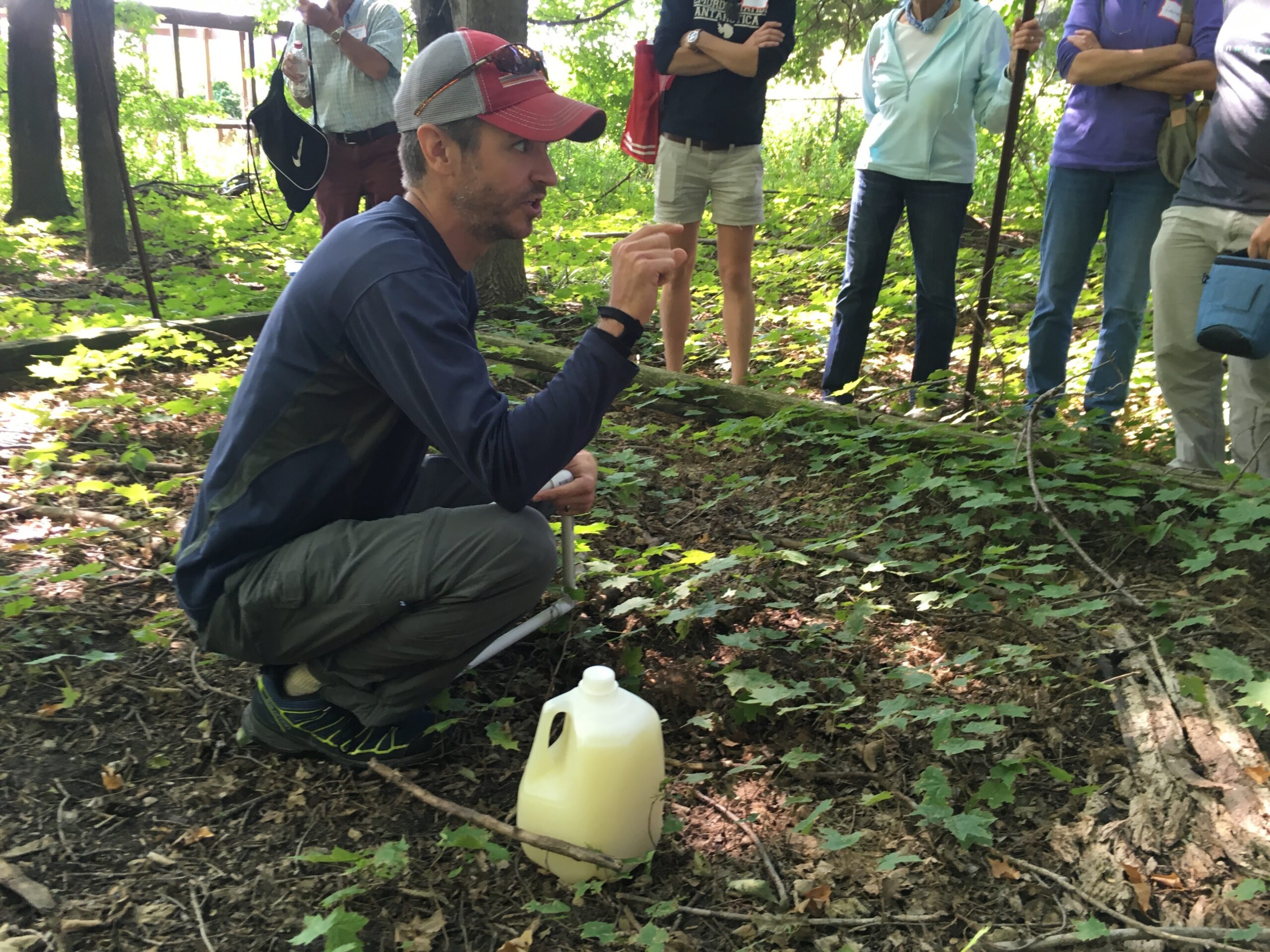 UW-Madison Arboretum ecologist Brad Herrick demonstrates how to survey for invasive jumping worms