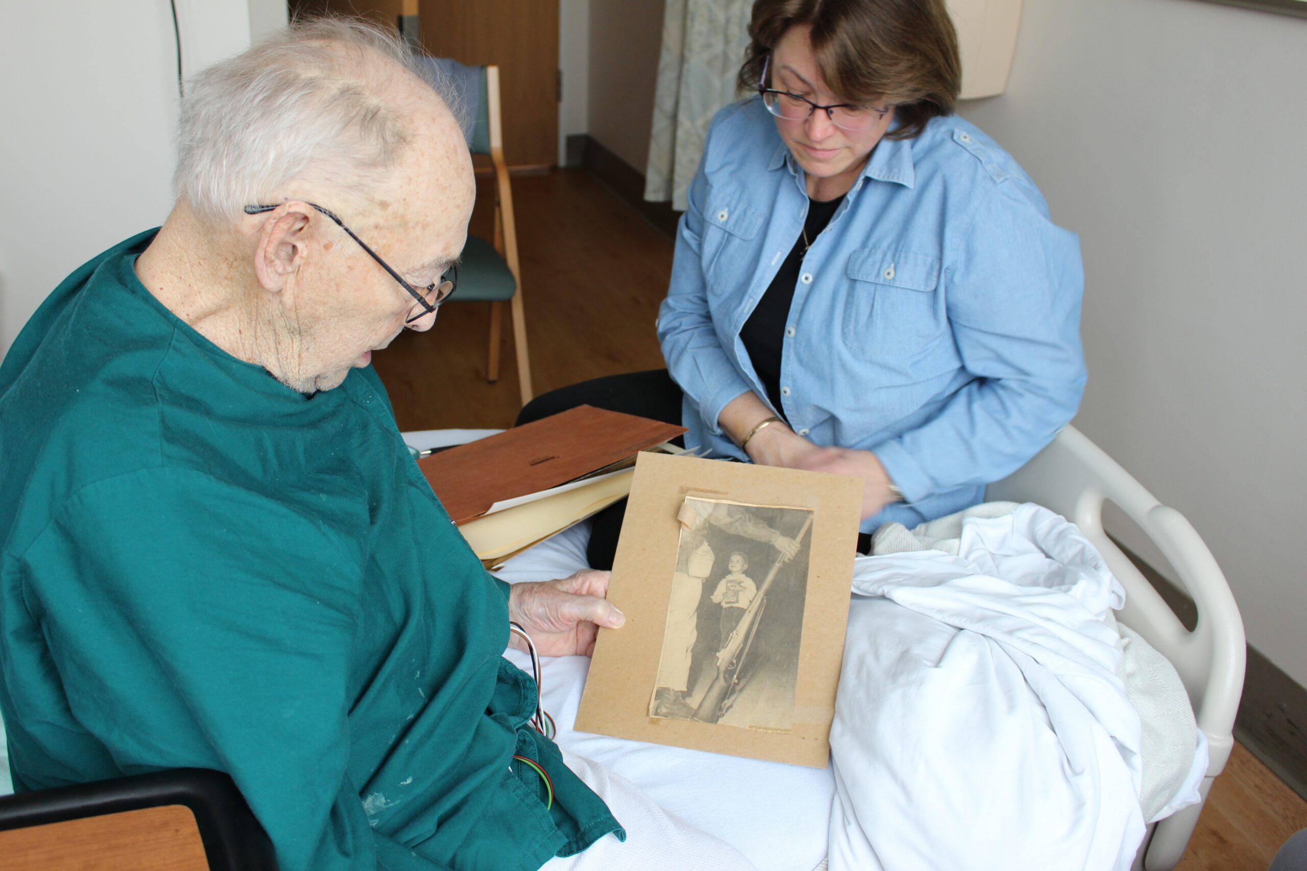 Veteran Ray Miller looks at an old press clipping from his time in the National Guard