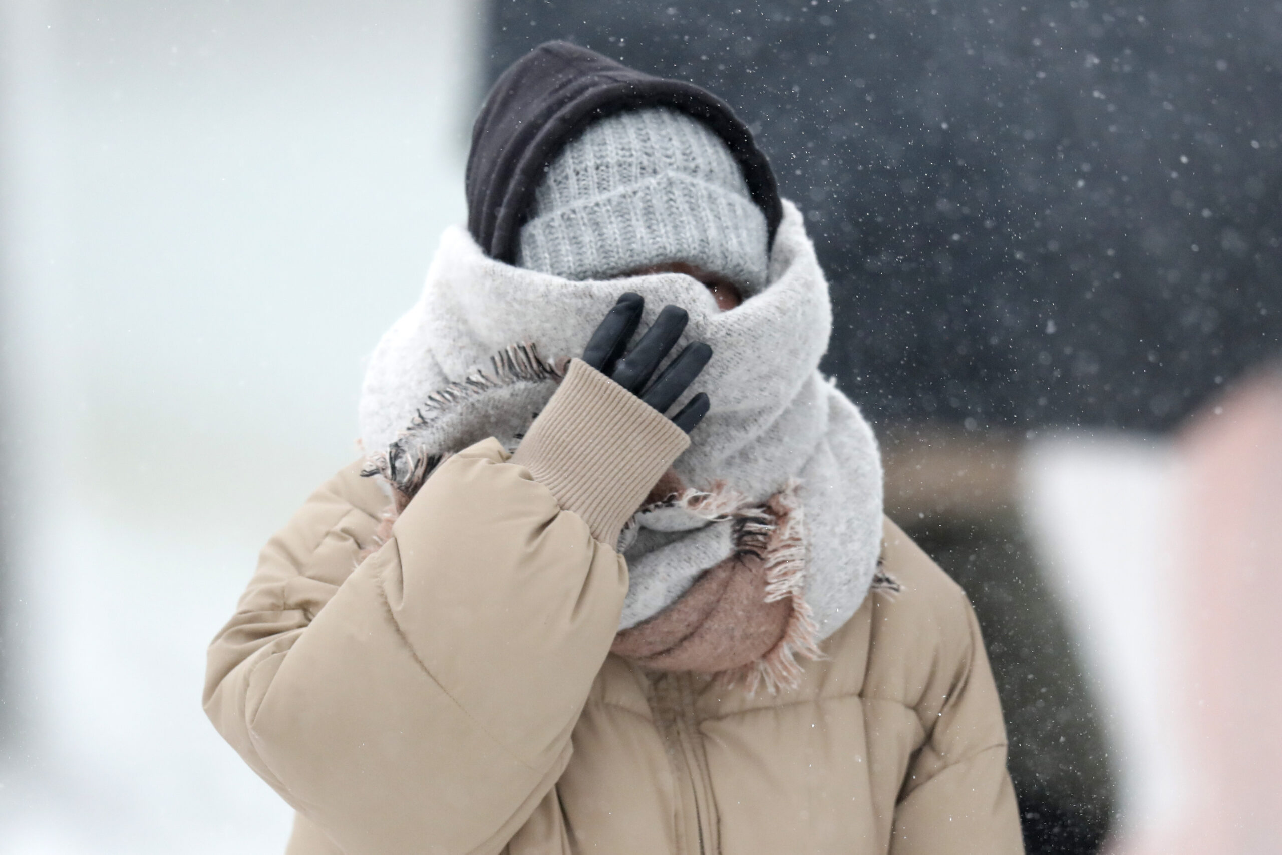 A woman braces in a stiff wind and blowing snow in Chicago.