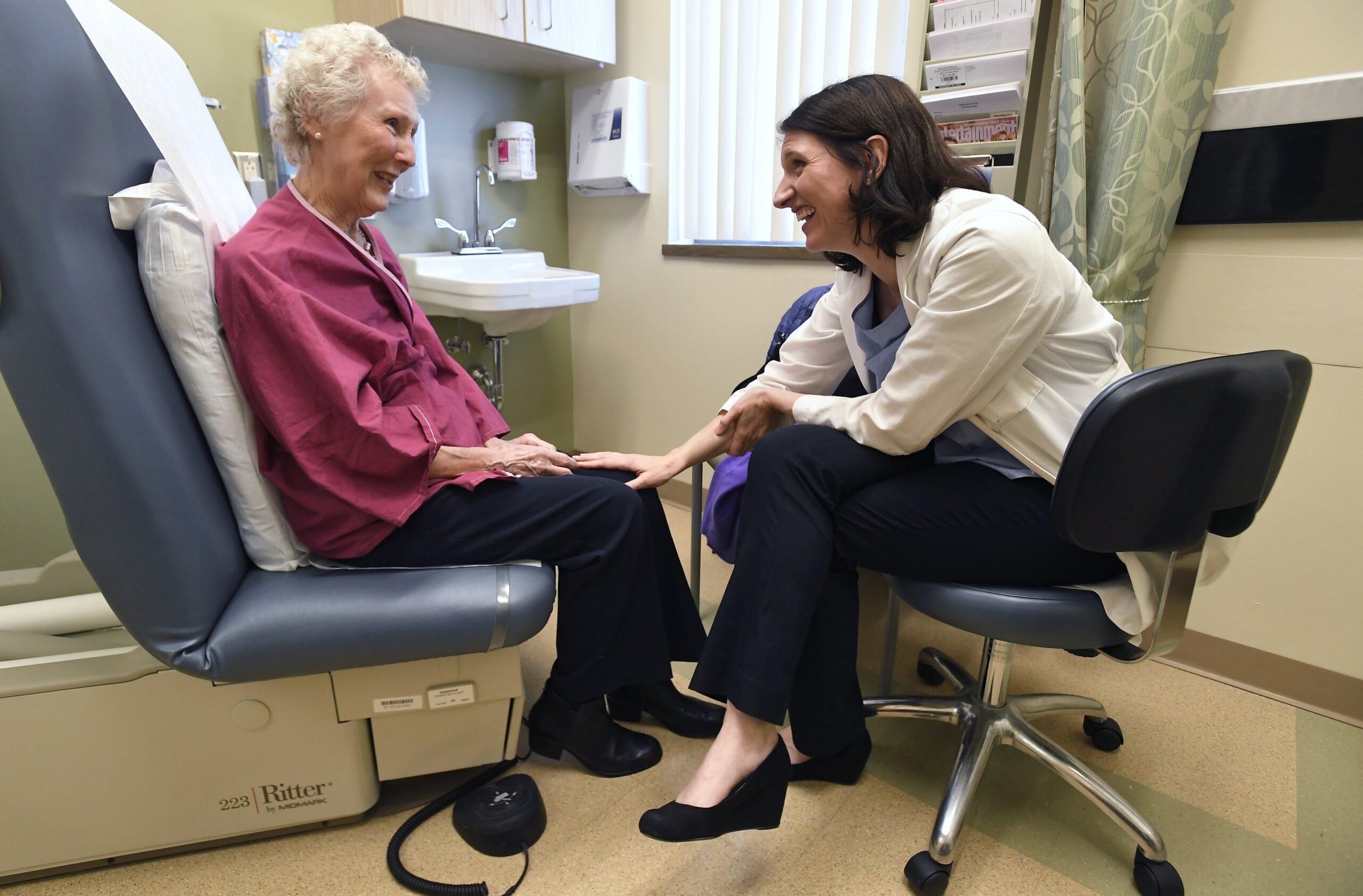 Dr. Allison Magnuson, left, speaks with patient Nancy Simpson