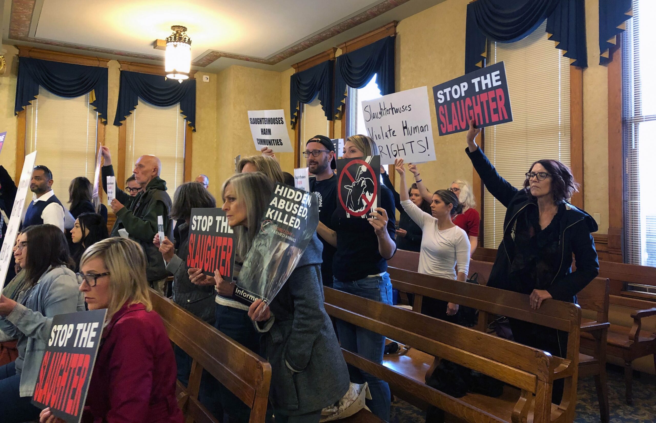 People protesting a slaughterhouse during a Milwaukee Common Council meeting