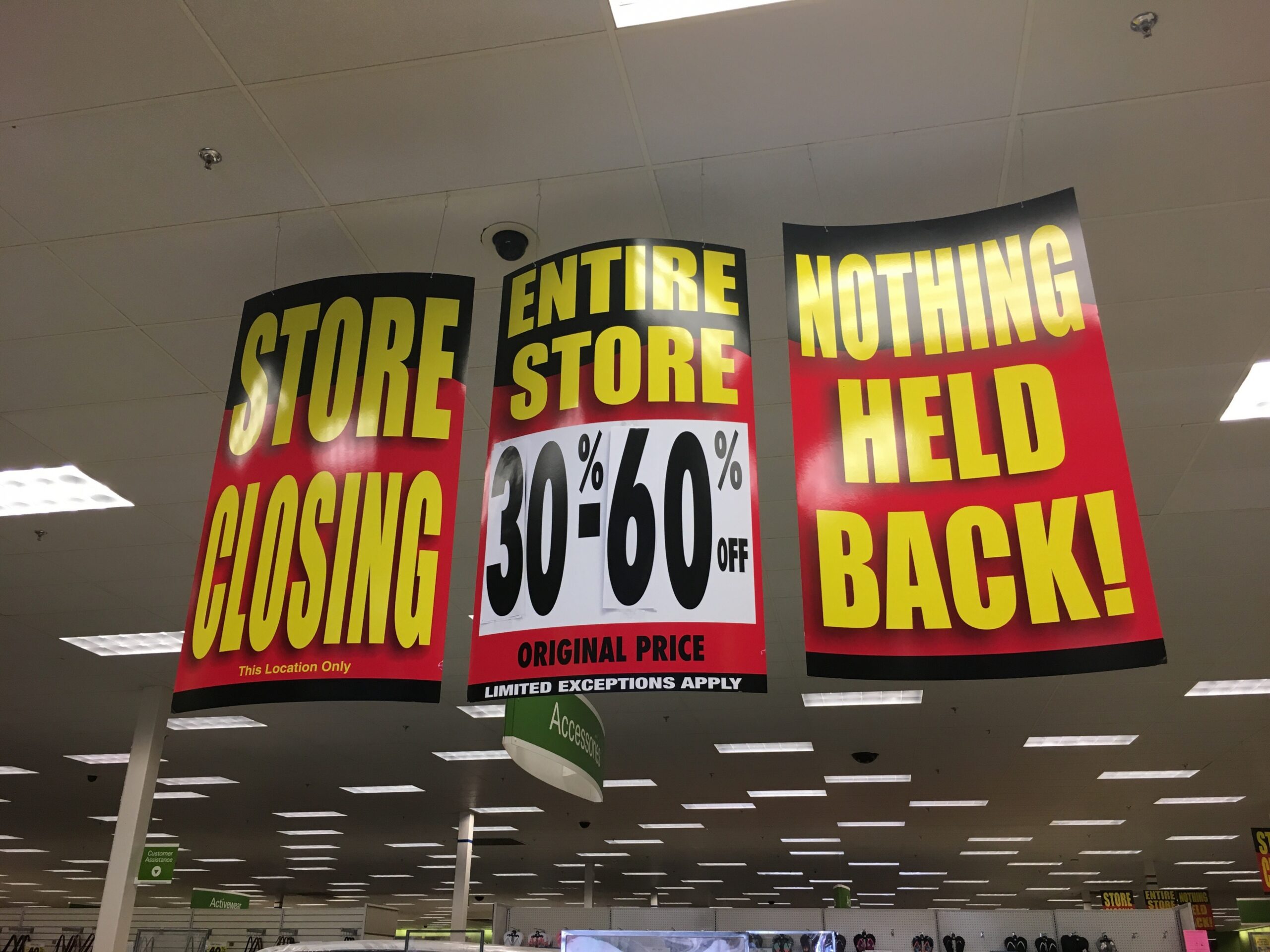 Store closing signs advertise sales