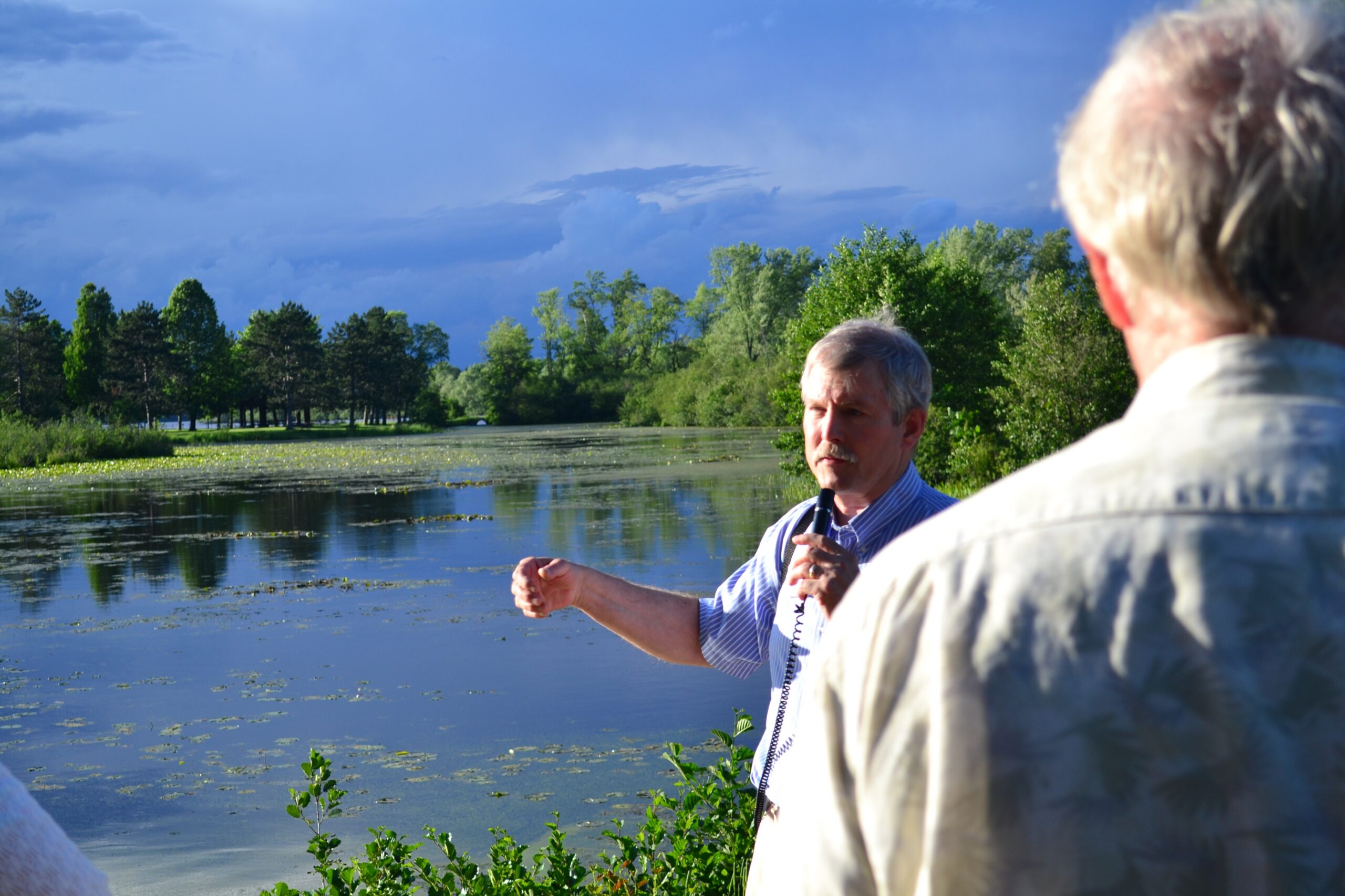Wausau area community leaders hear a presentation by Marathon County Parks Director Bill Duncanson at Blue Gill Bay Pond, June, 2015