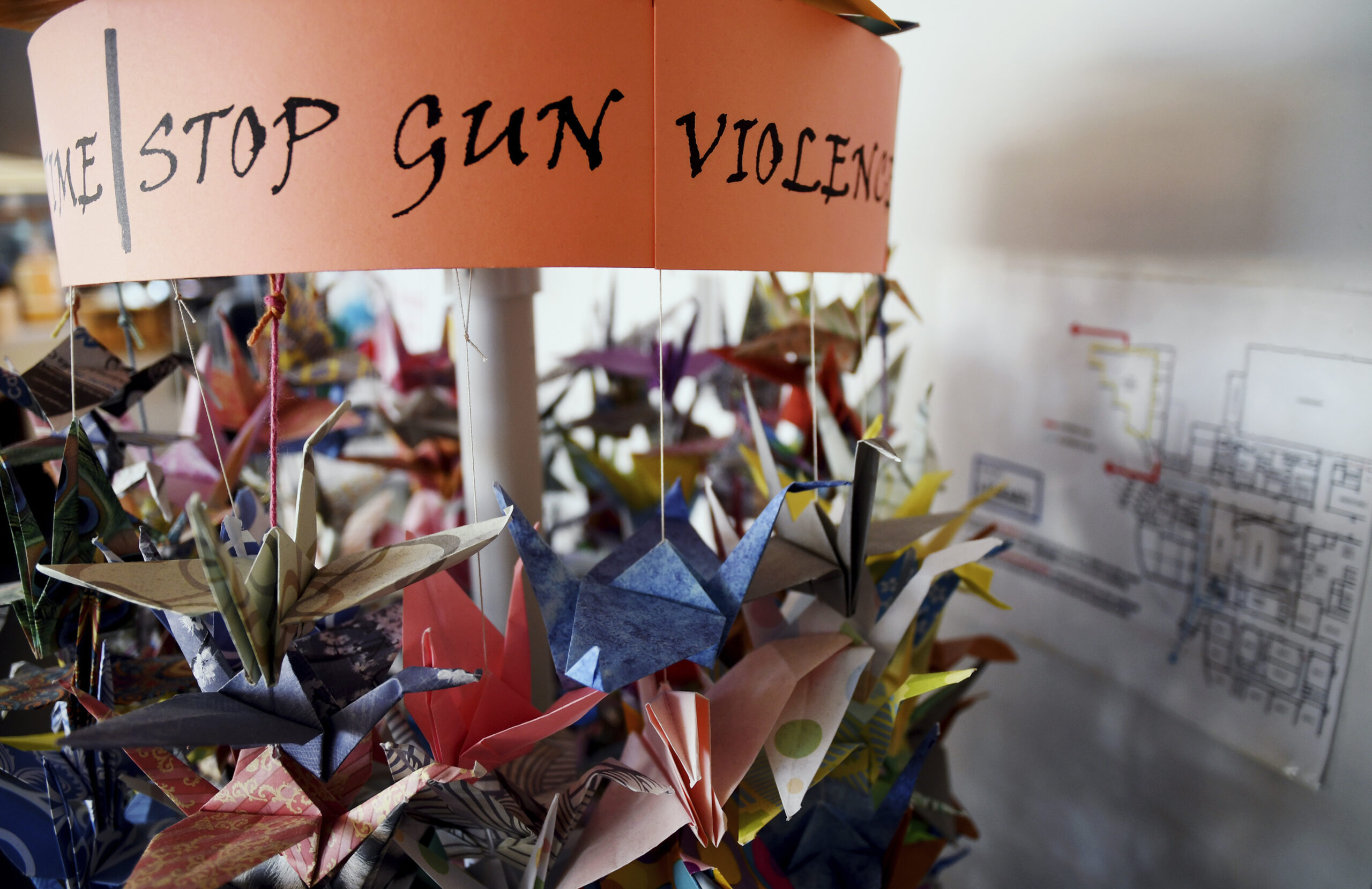 In this March 23, 2019, file photo, origami cranes, a symbol of peace, hang in the Columbine High School library in Littleton, Colo., near where several survivors and family members of the victims gathered to speak about the 20th anniversary of the April