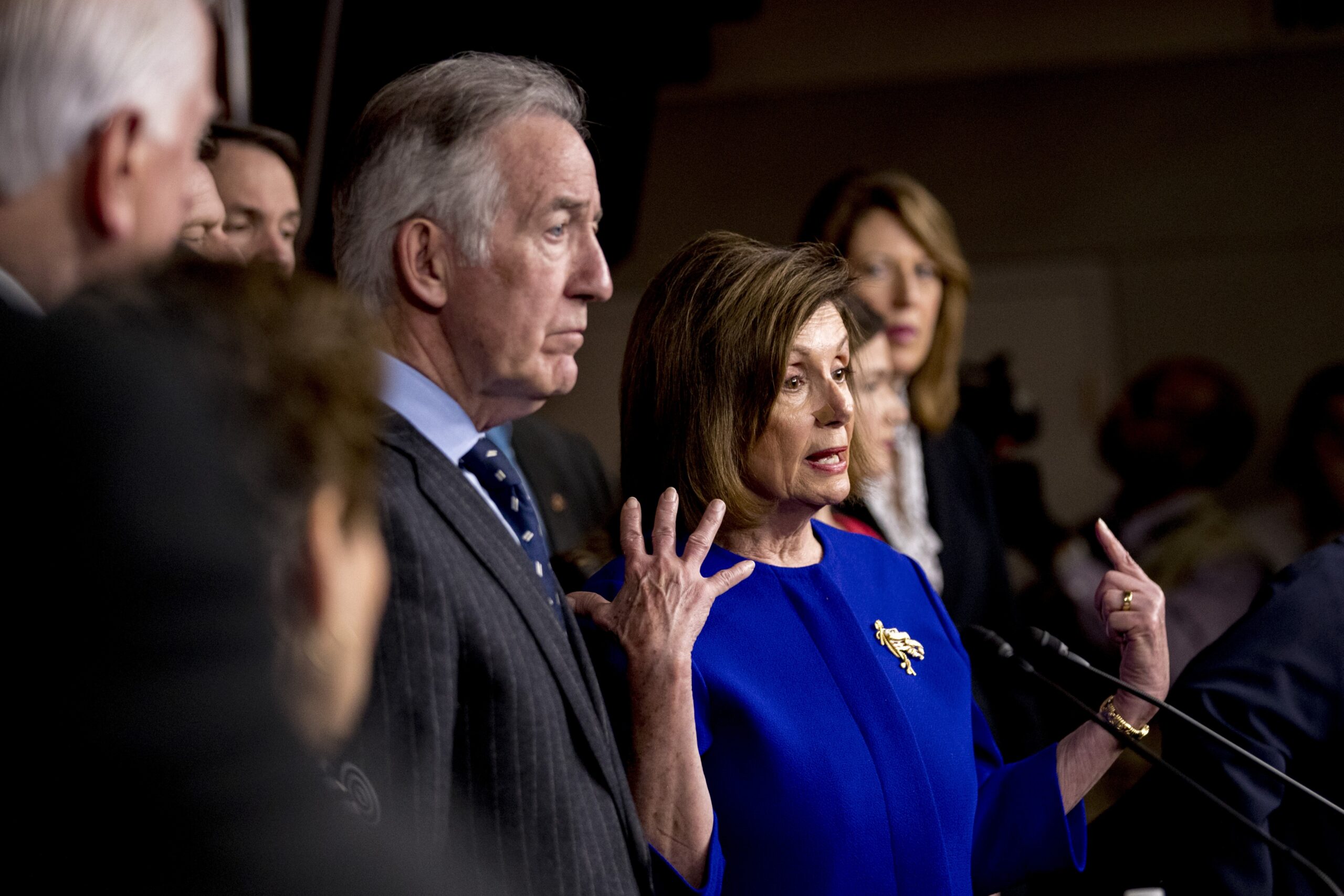 House Speaker Nancy Pelosi of Calif., accompanied by Chairman of the House Ways and Means Committee Richard Neal, D-Mass