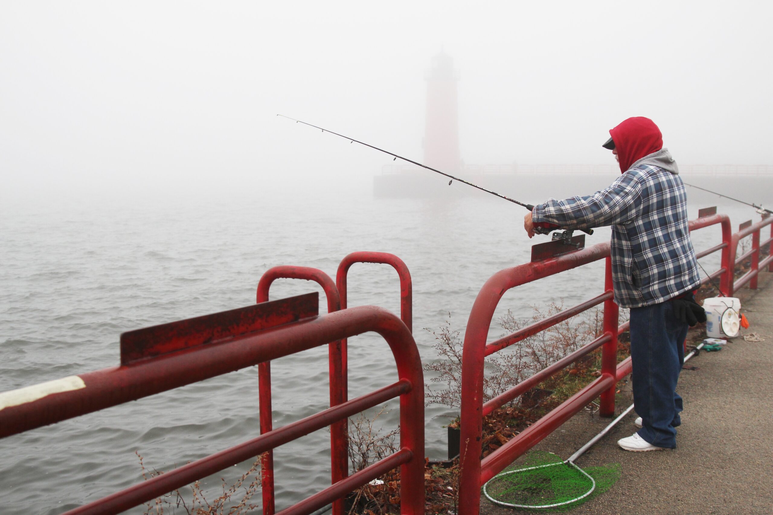 A man fishes from a pier in Milwaukee