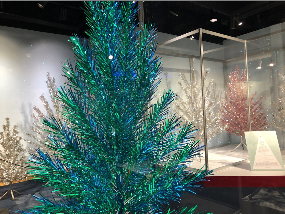 A green and blue Evergleam tree is shown on display at a Wisconsin Historical Society exhibit