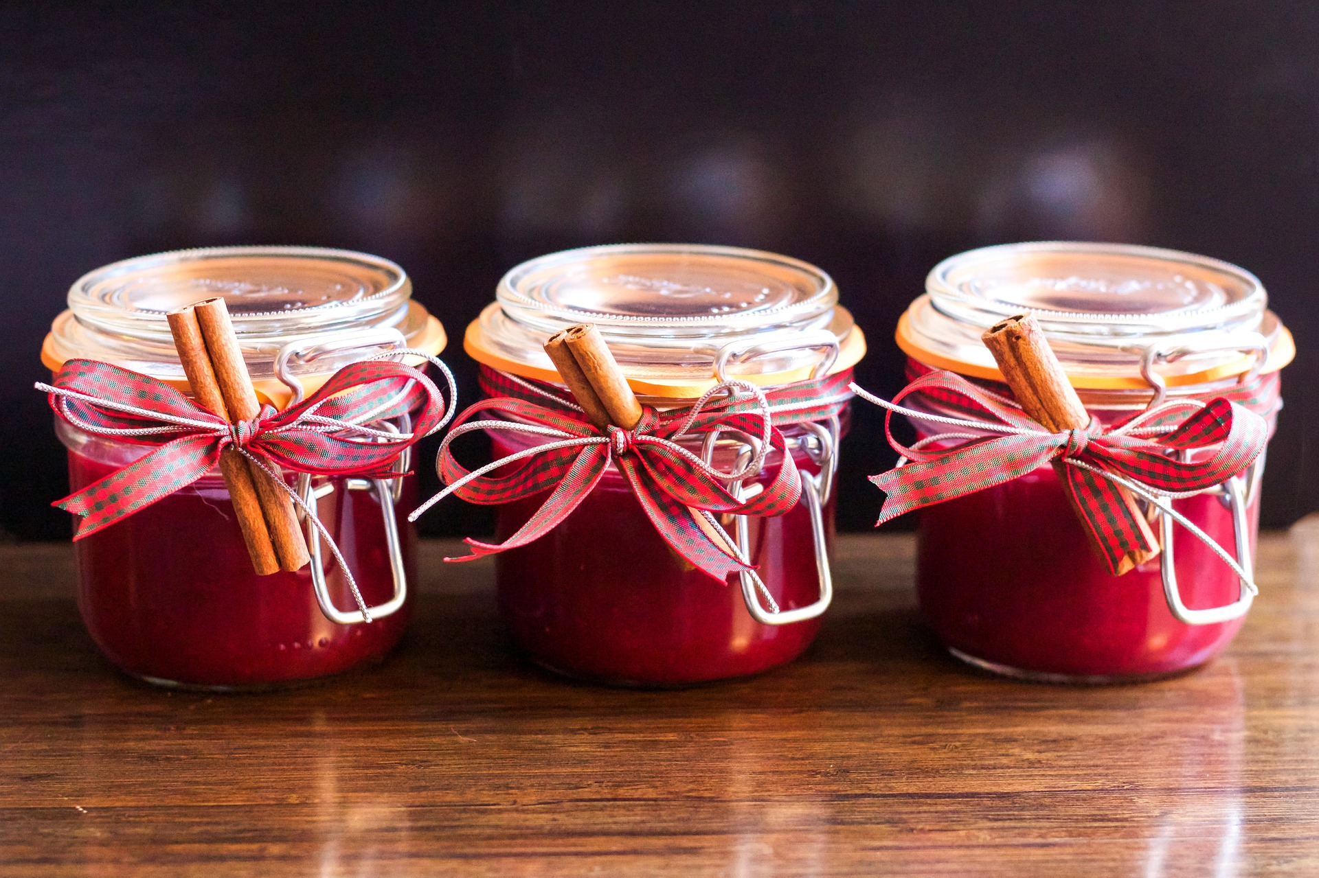 Three jars of cranberry jam with Christmas decoration.