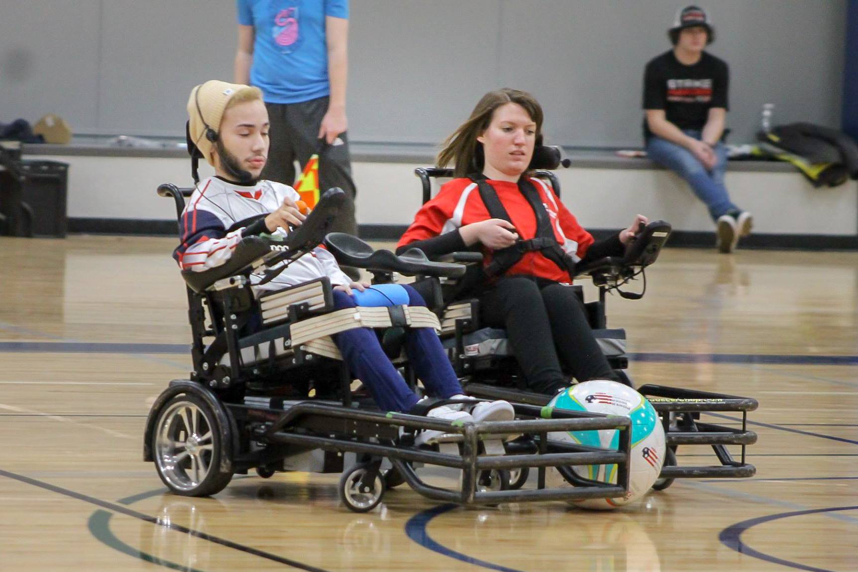 Competitors playing power soccer, including a member of the Wisconsin Warriors