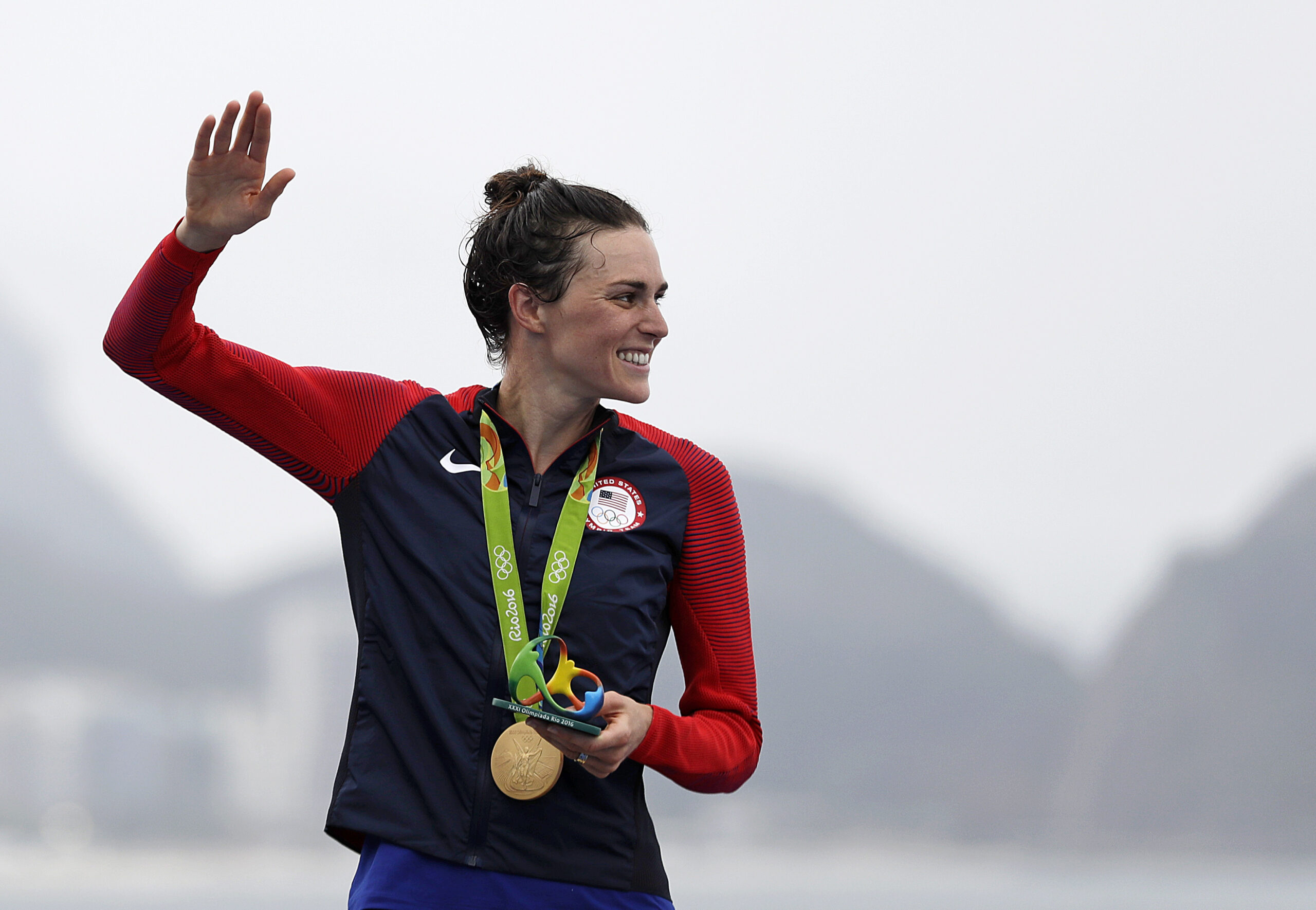 Gwen Jorgensen waves after receiving the gold medal in the women's triathlon at the 2016 Summer Olympics